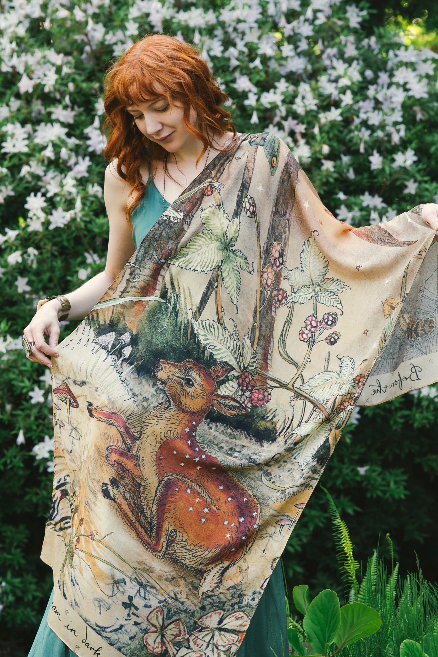 Model wearing an enchanting scarf featuring Charles van Sandwyck's illustrations, crafted from airy bamboo-based viscose with a touch of whimsical magic - Market of Stars