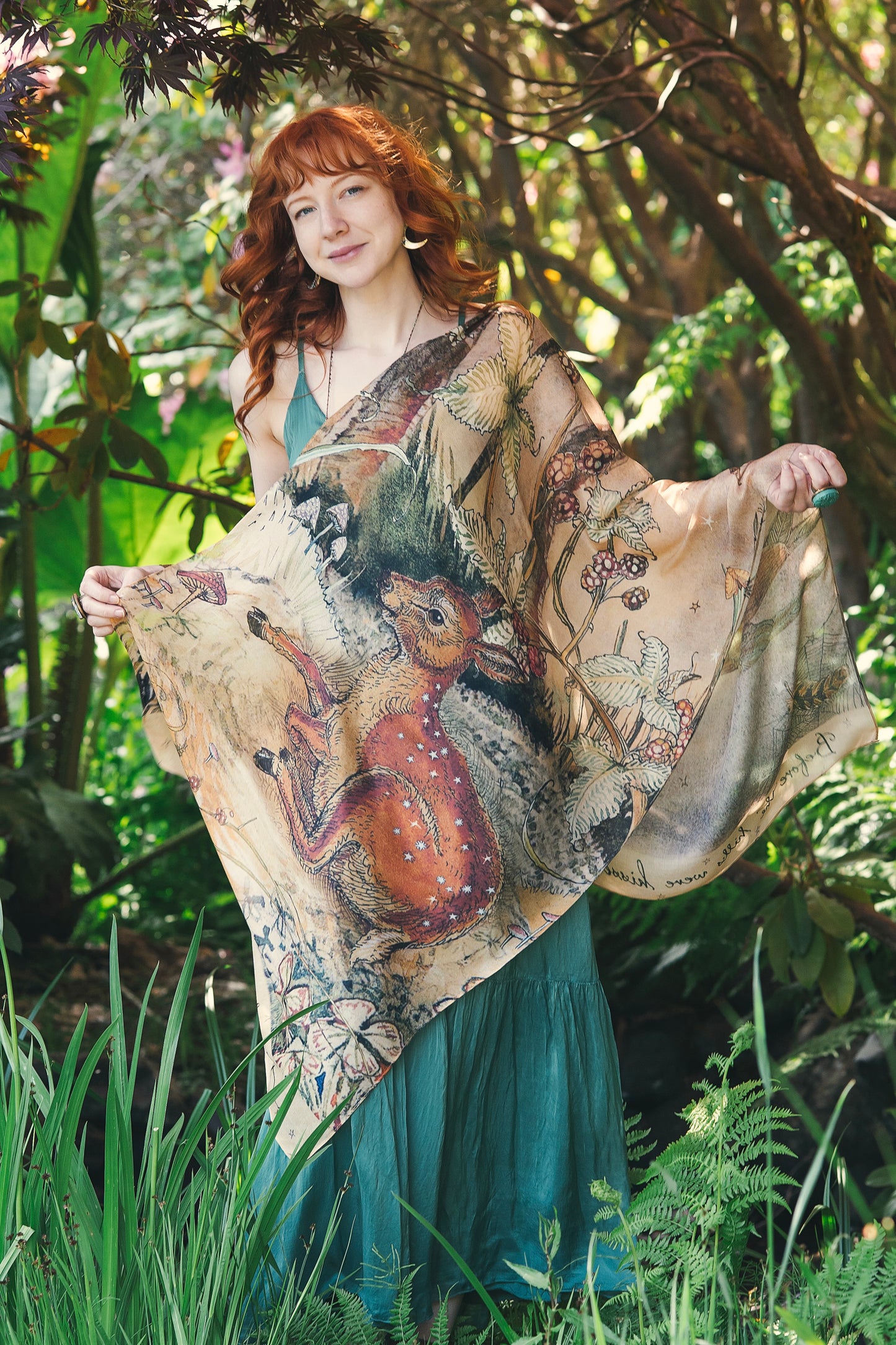 Model wearing an enchanting scarf featuring Charles van Sandwyck's illustrations, crafted from airy bamboo-based viscose with a touch of whimsical magic - Market of Stars