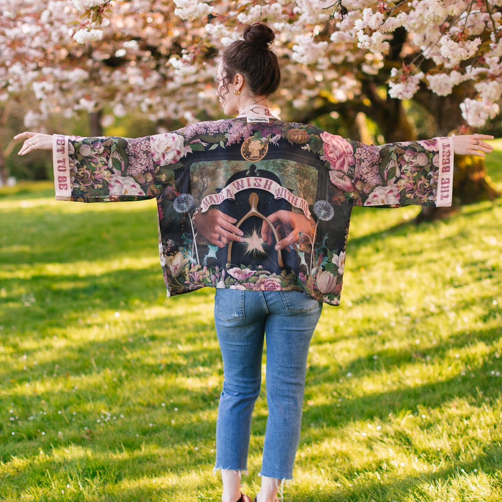 
                  
                    Model wearing cropped kimono featuring gold wishbone–vintage coin–evening star–dandelion–and spring floral collage with “Make a wish” banner – Market of Stars
                  
                