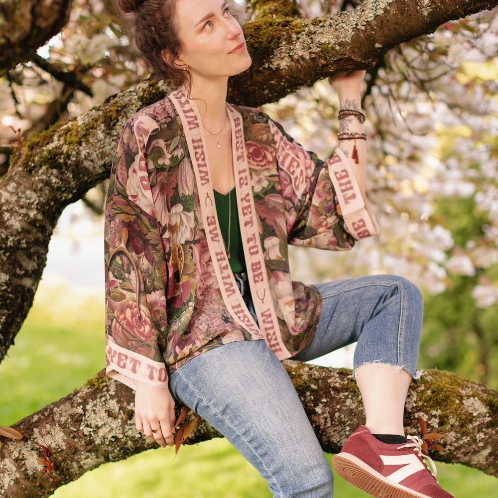 
                  
                    Model wearing cropped kimono featuring gold wishbone–vintage coin–evening star–dandelion–and spring floral collage with “Make a wish” banner – Market of Stars
                  
                