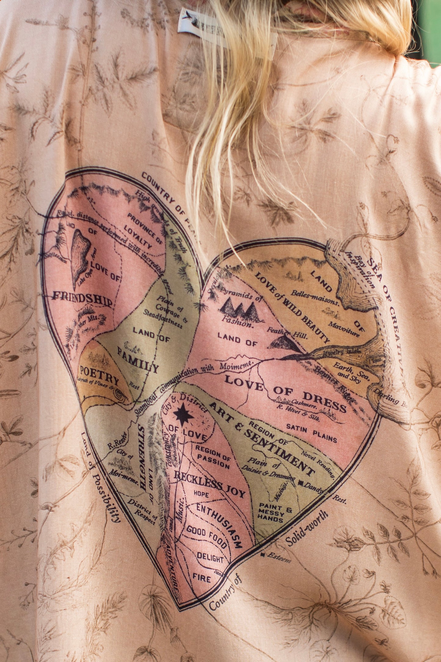 Model wearing map print kimono featuring a reimagined 1846 artwork titled A Map of the Open Country of a Woman’s Heart – Market of Stars