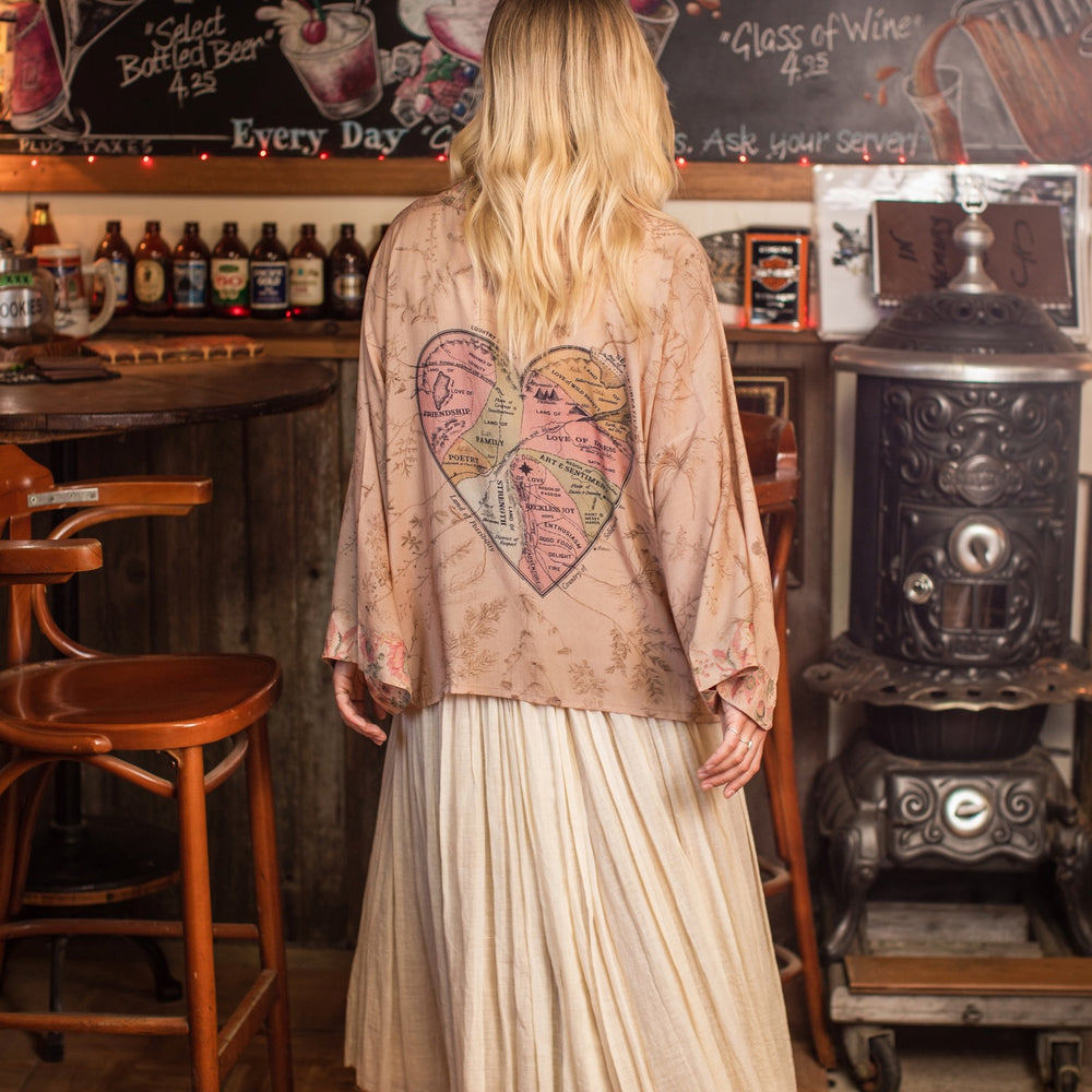 
                  
                    Model wearing map print kimono featuring a reimagined 1846 artwork titled A Map of the Open Country of a Woman’s Heart – Market of Stars
                  
                