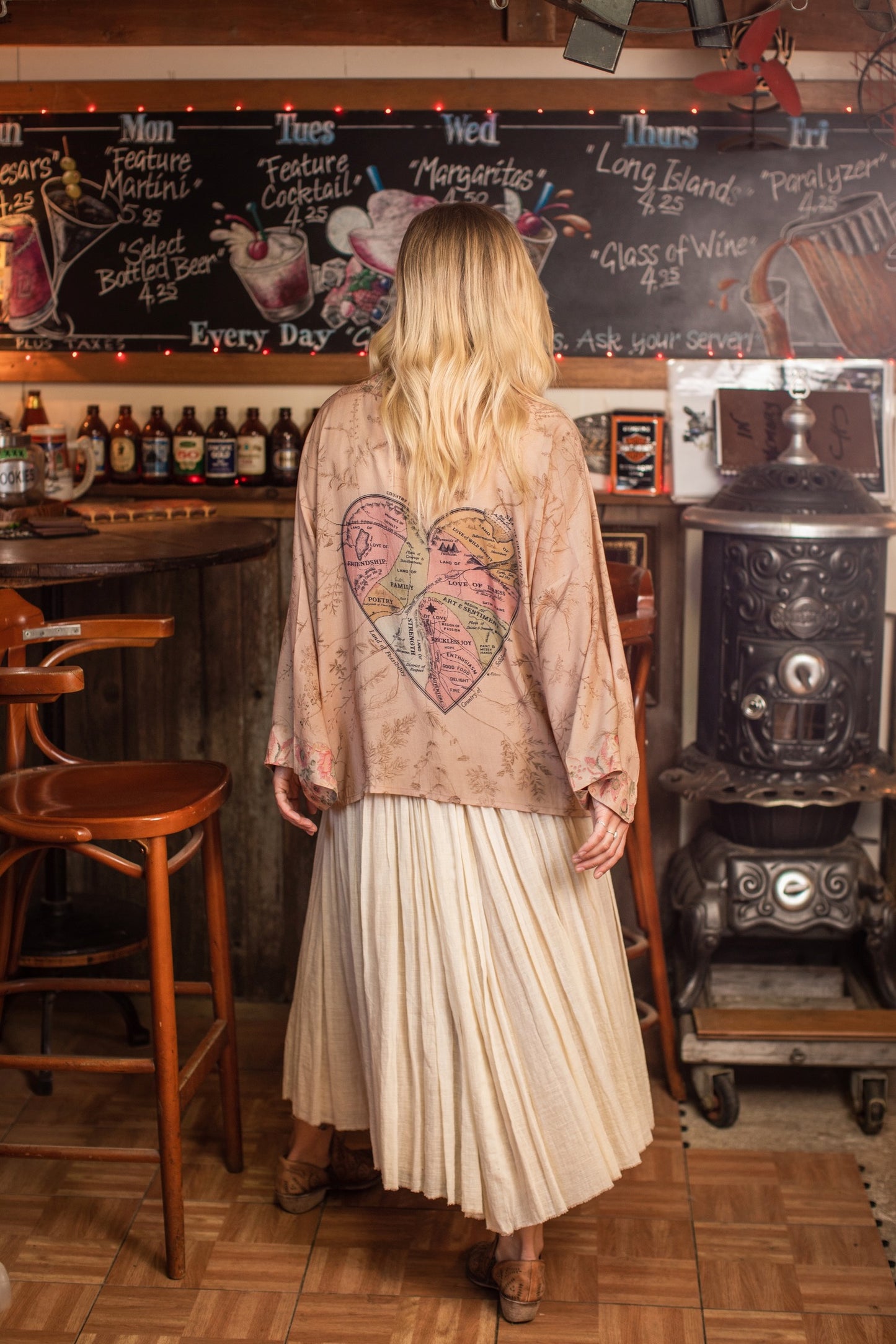 Model wearing map print kimono featuring a reimagined 1846 artwork titled A Map of the Open Country of a Woman’s Heart – Market of Stars