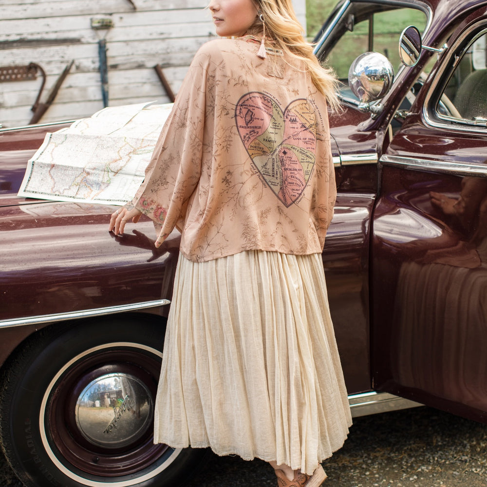 
                  
                    Model wearing map print kimono featuring a reimagined 1846 artwork titled A Map of the Open Country of a Woman’s Heart – Market of Stars
                  
                