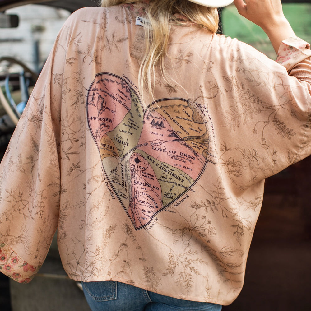 
                  
                    Model wearing map print kimono featuring a reimagined 1846 artwork titled A Map of the Open Country of a Woman’s Heart – Market of Stars
                  
                
