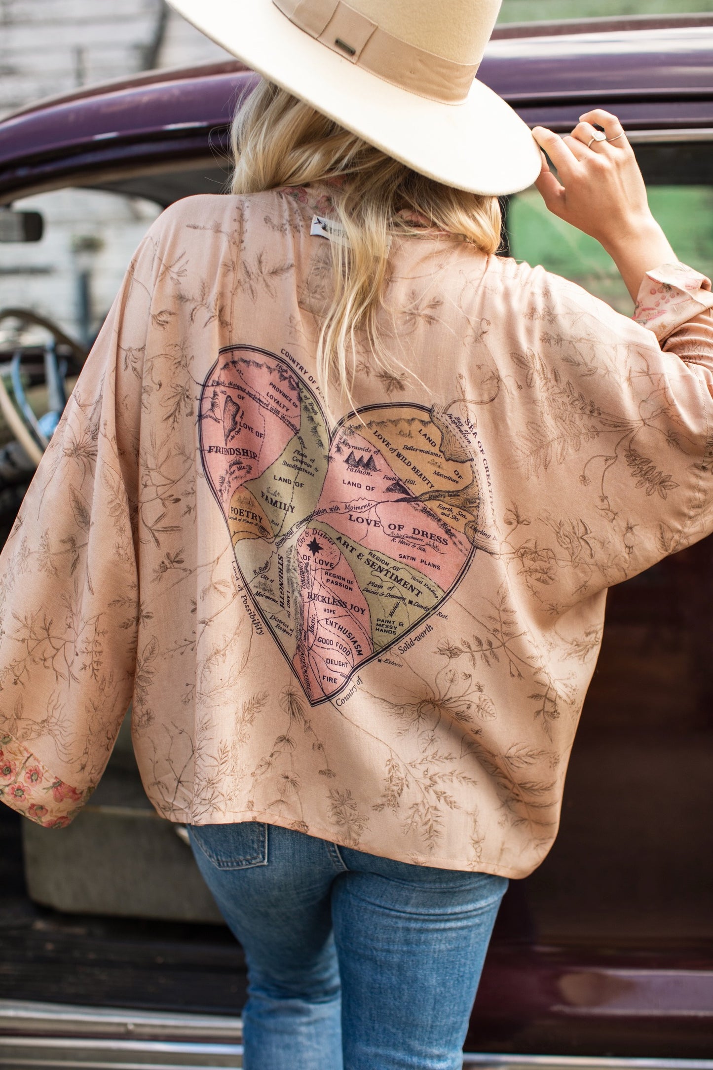 Model wearing map print kimono featuring a reimagined 1846 artwork titled A Map of the Open Country of a Woman’s Heart – Market of Stars