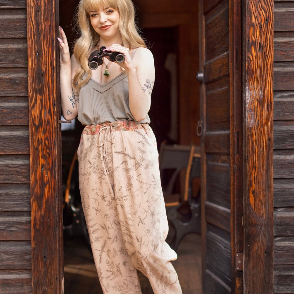 
                  
                    Model wearing artist pants in oat featuring reimagined vintage 1846 map of a woman’s heart with playful updated place names – Market of Stars
                  
                