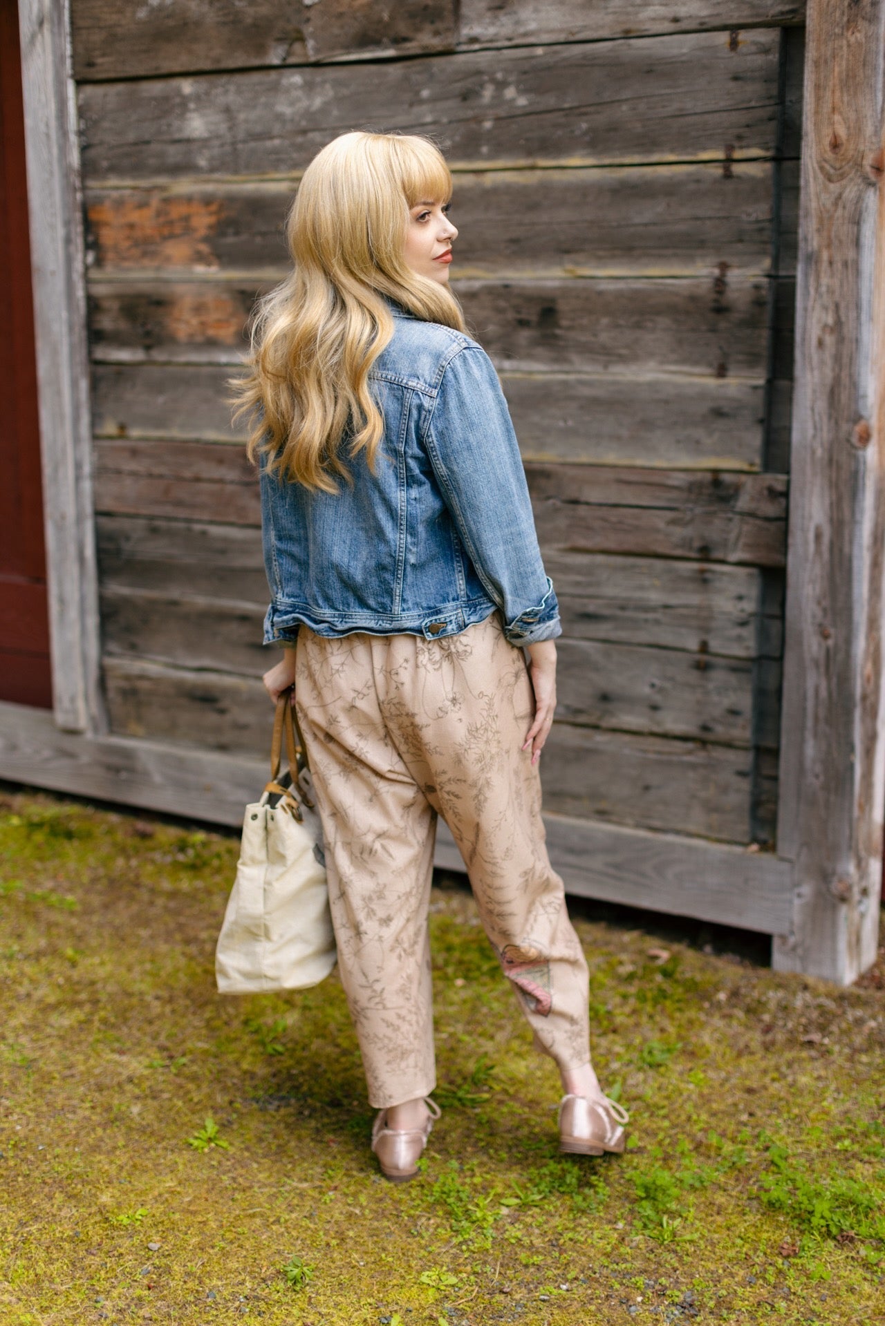 Model wearing artist pants in oat featuring reimagined vintage 1846 map of a woman’s heart with playful updated place names – Market of Stars
