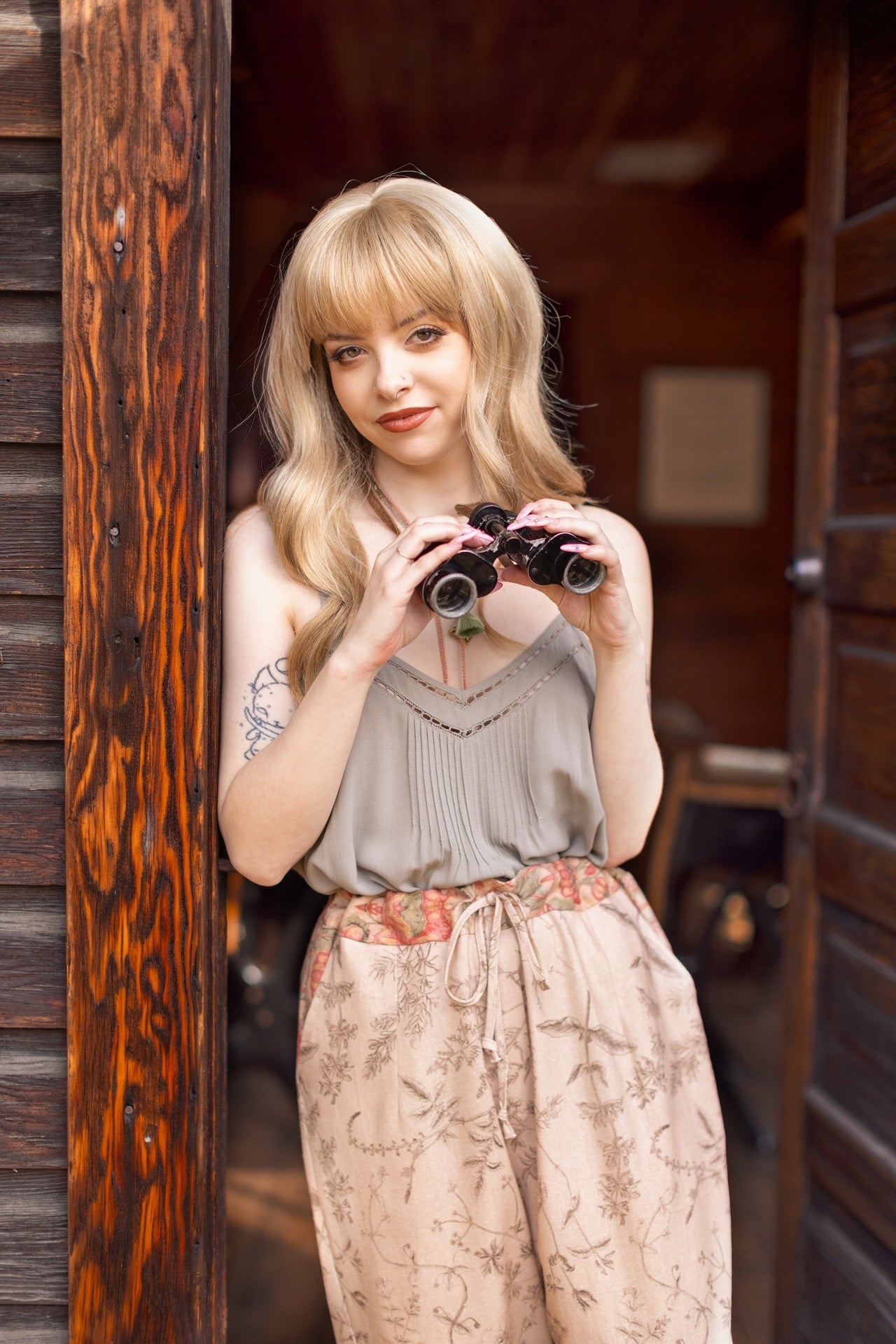 Model wearing artist pants in oat featuring reimagined vintage 1846 map of a woman’s heart with playful updated place names – Market of Stars
