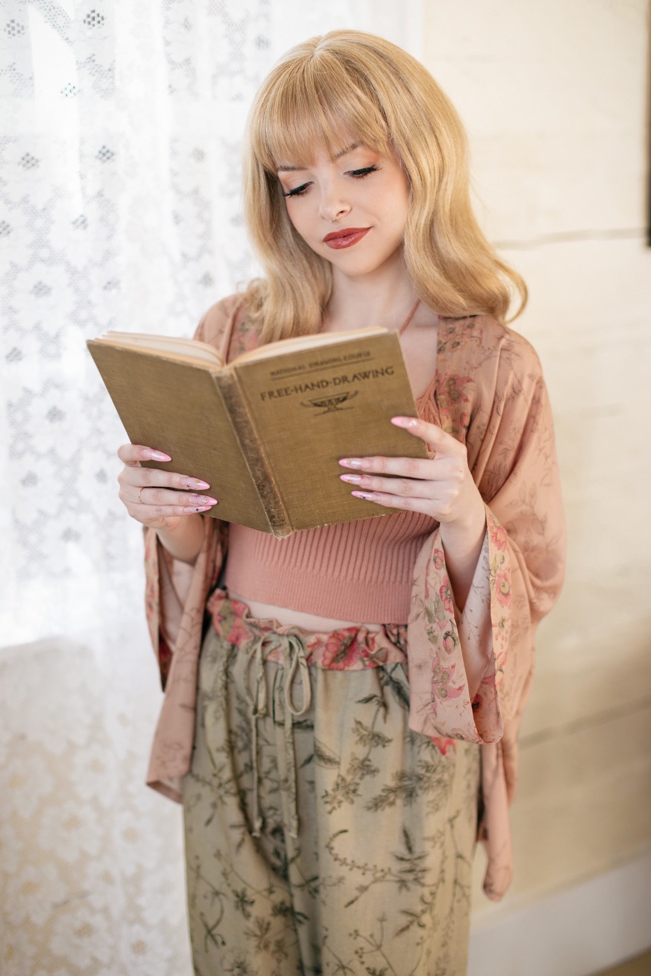 Model wearing artist pants in sage featuring reimagined vintage 1846 map of a woman’s heart with playful updated place names – Market of Stars