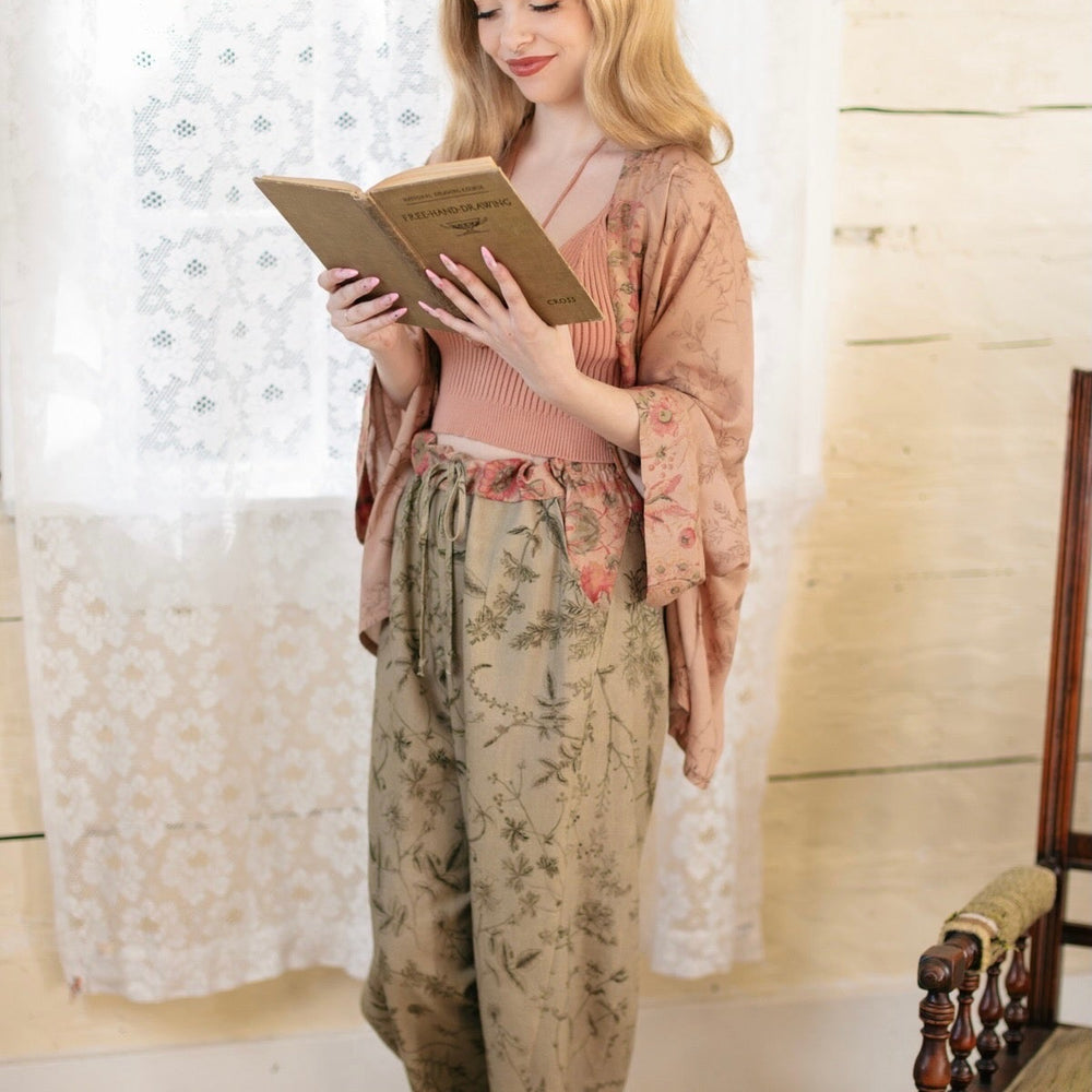 
                  
                    Model wearing artist pants in sage featuring reimagined vintage 1846 map of a woman’s heart with playful updated place names – Market of Stars
                  
                