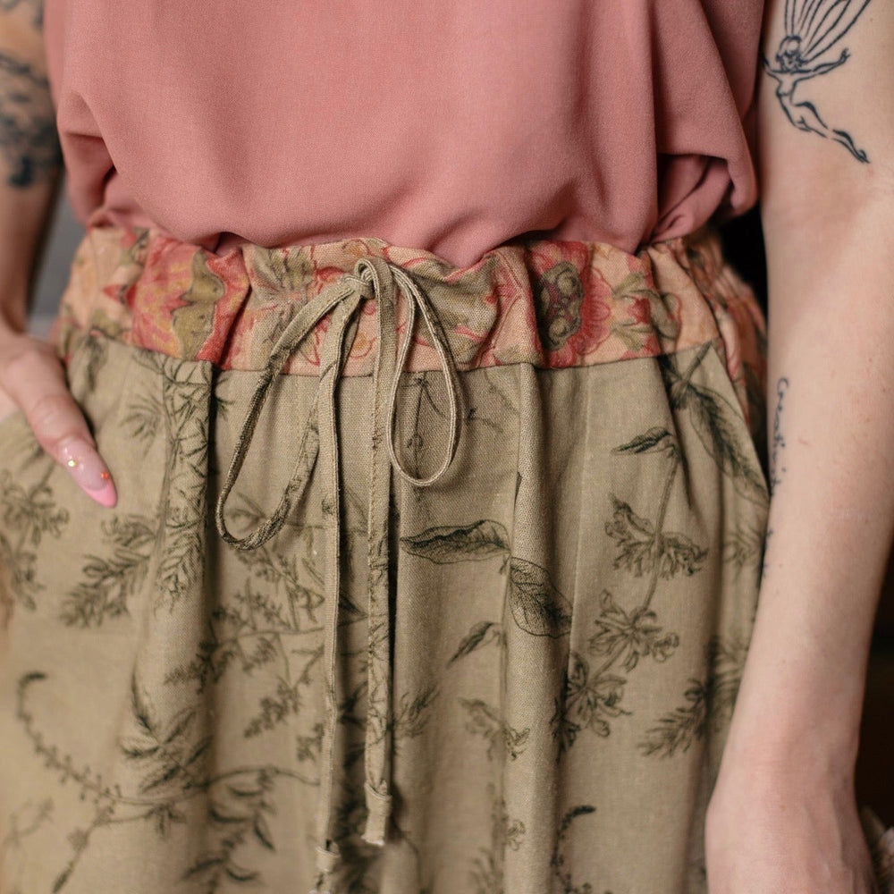 
                  
                    Model wearing artist pants in sage featuring reimagined vintage 1846 map of a woman’s heart with playful updated place names – Market of Stars
                  
                