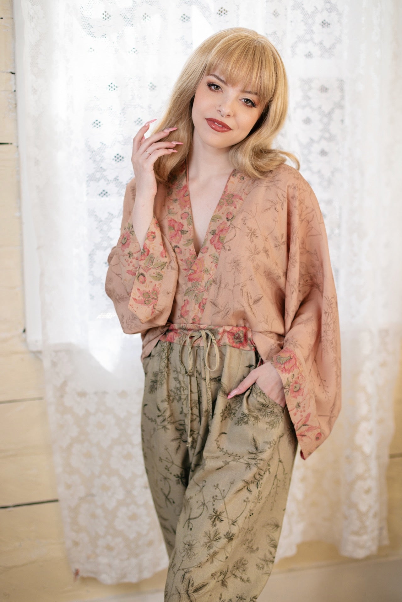 Model wearing artist pants in sage featuring reimagined vintage 1846 map of a woman’s heart with playful updated place names – Market of Stars