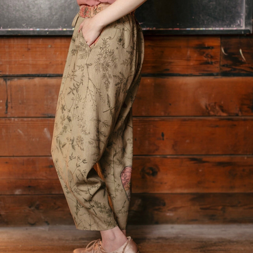 
                  
                    Model wearing artist pants in sage featuring reimagined vintage 1846 map of a woman’s heart with playful updated place names – Market of Stars
                  
                