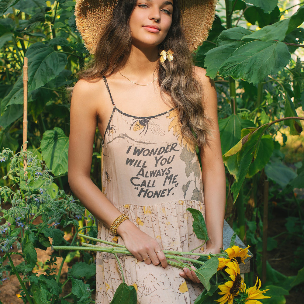 Model wearing the Milk & Honey Bohéme Slip Dress featuring nostalgic 1904 Brooklyn artwork, vintage woodcut stars, and Hoytema’s antique floral print – Market of Stars.