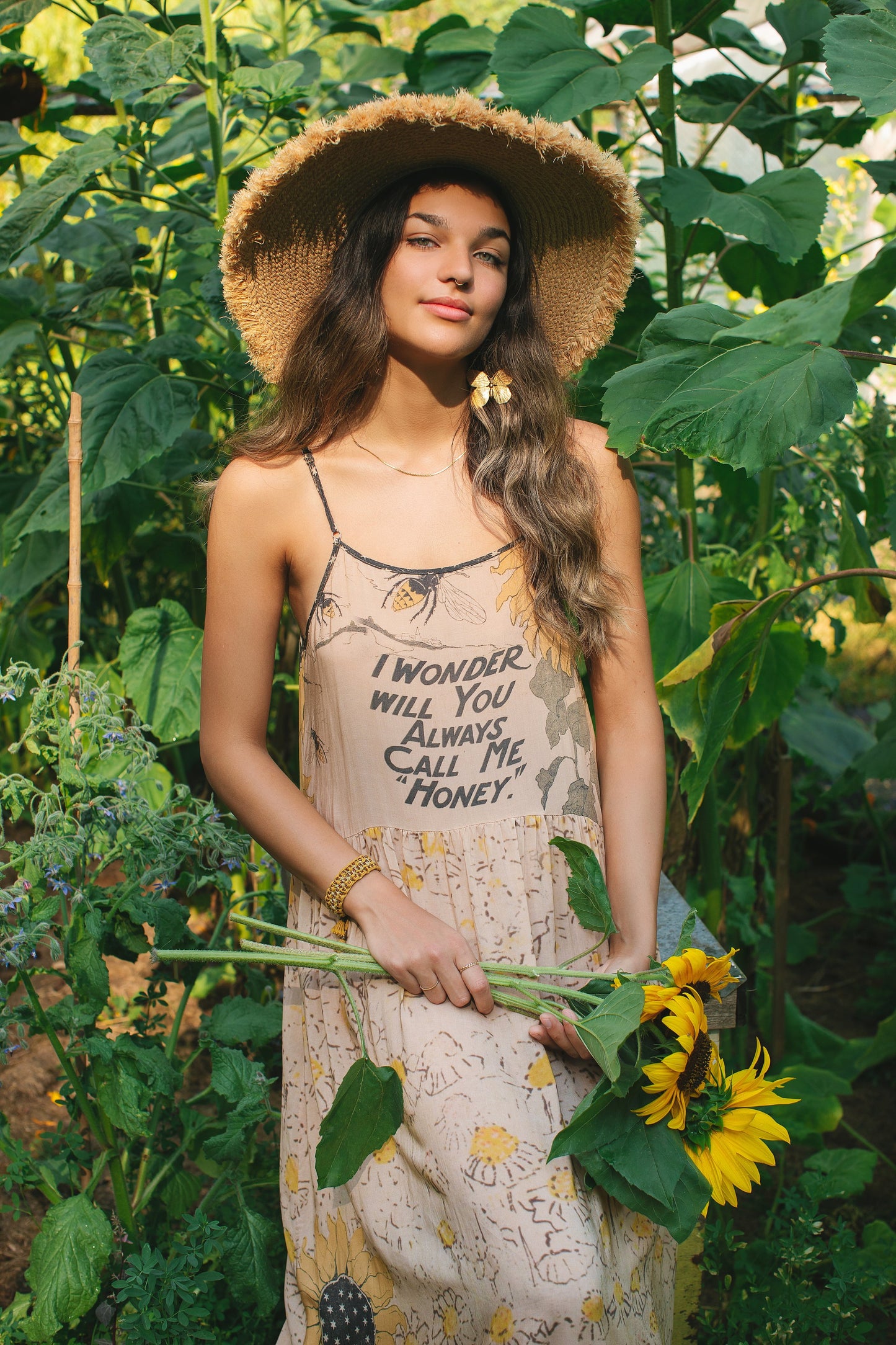 Model wearing the Milk & Honey Bohéme Slip Dress featuring nostalgic 1904 Brooklyn artwork, vintage woodcut stars, and Hoytema’s antique floral print – Market of Stars.