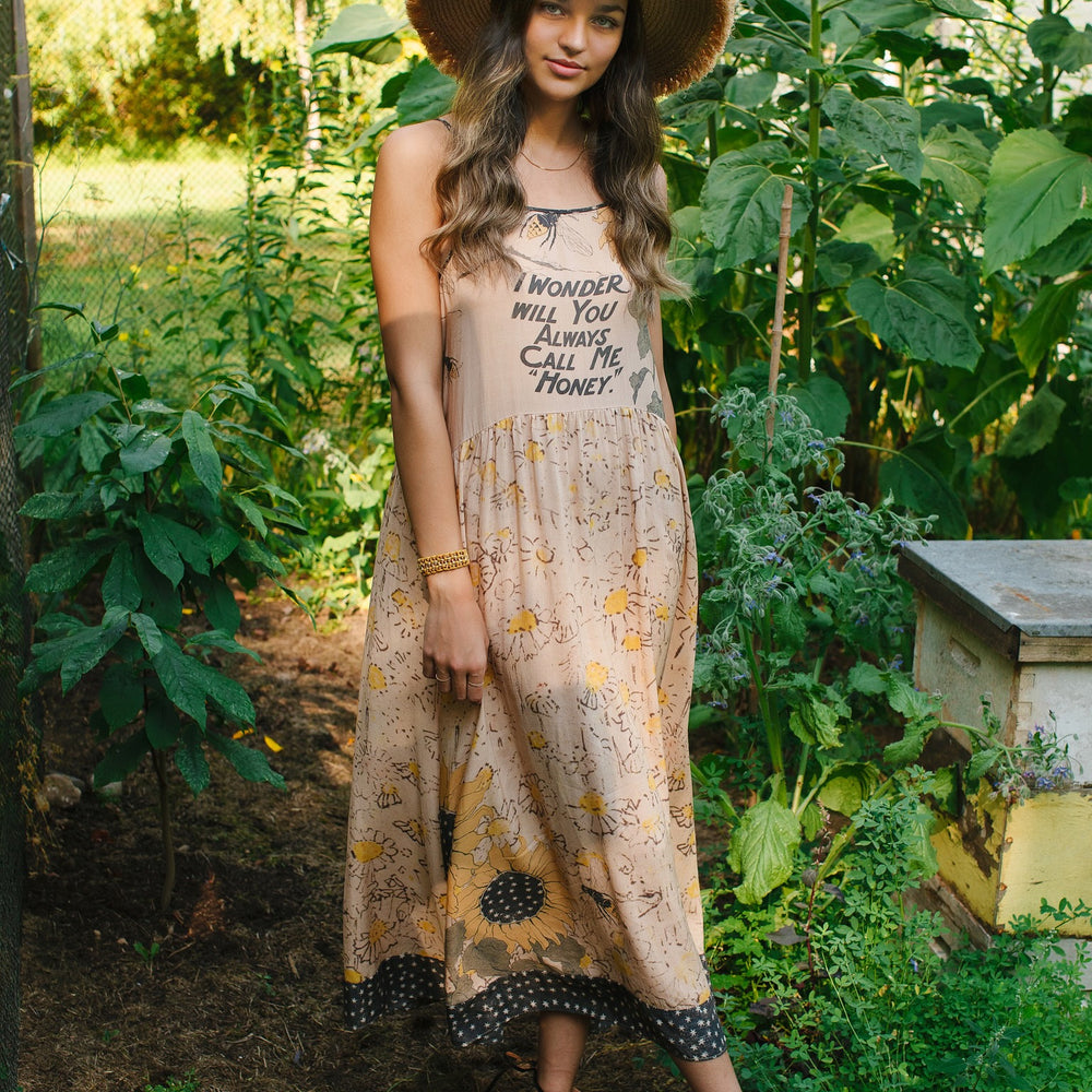 Model wearing the Milk & Honey Bohéme Slip Dress featuring nostalgic 1904 Brooklyn artwork, vintage woodcut stars, and Hoytema’s antique floral print – Market of Stars.