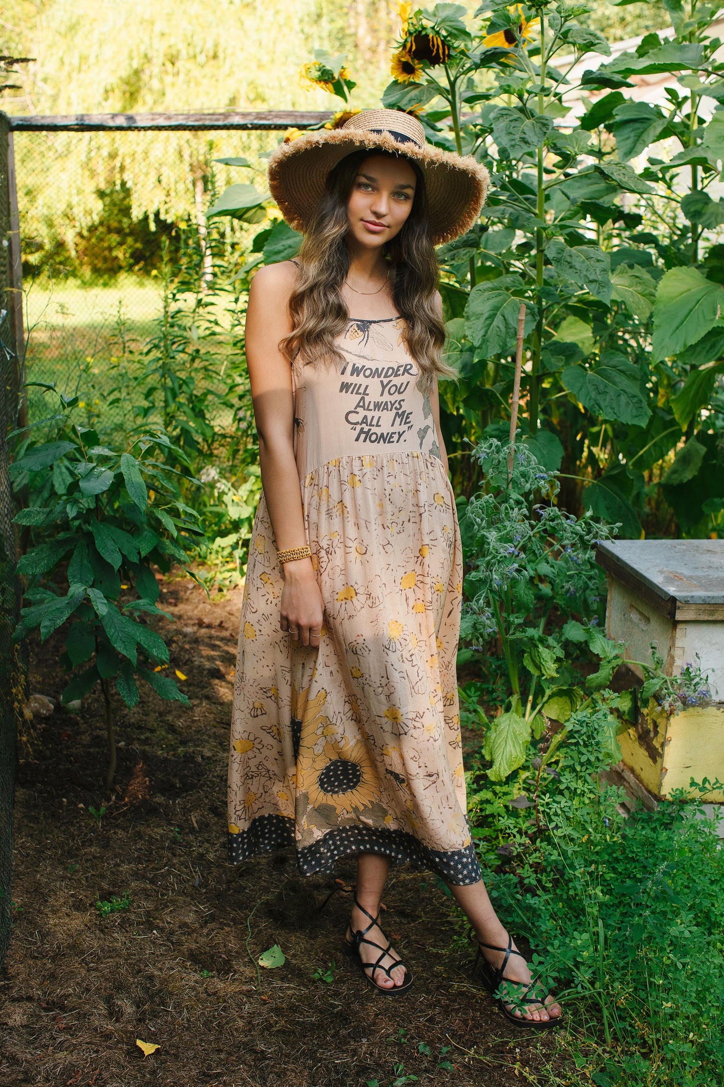 Model wearing the Milk & Honey Bohéme Slip Dress featuring nostalgic 1904 Brooklyn artwork, vintage woodcut stars, and Hoytema’s antique floral print – Market of Stars.