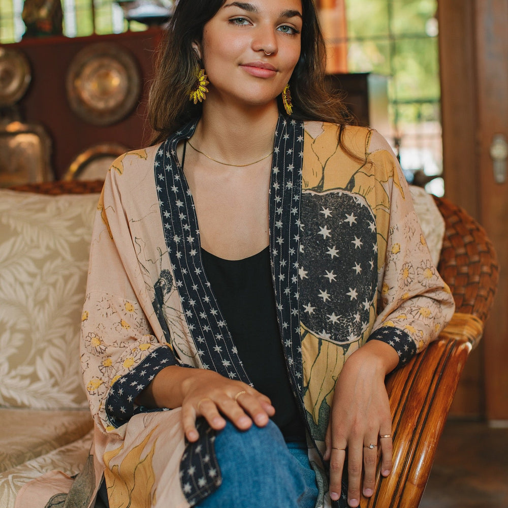 
                  
                    Model wearing our matinee length kimono featuring vintage-inspired Milk & Honey print with 1904 typography and floral woodcuts – Market of Stars
                  
                