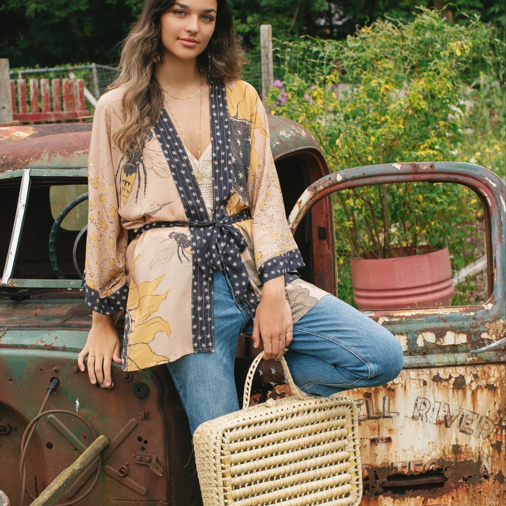 
                  
                    Model wearing our matinee length kimono featuring vintage-inspired Milk & Honey print with 1904 typography and floral woodcuts – Market of Stars
                  
                