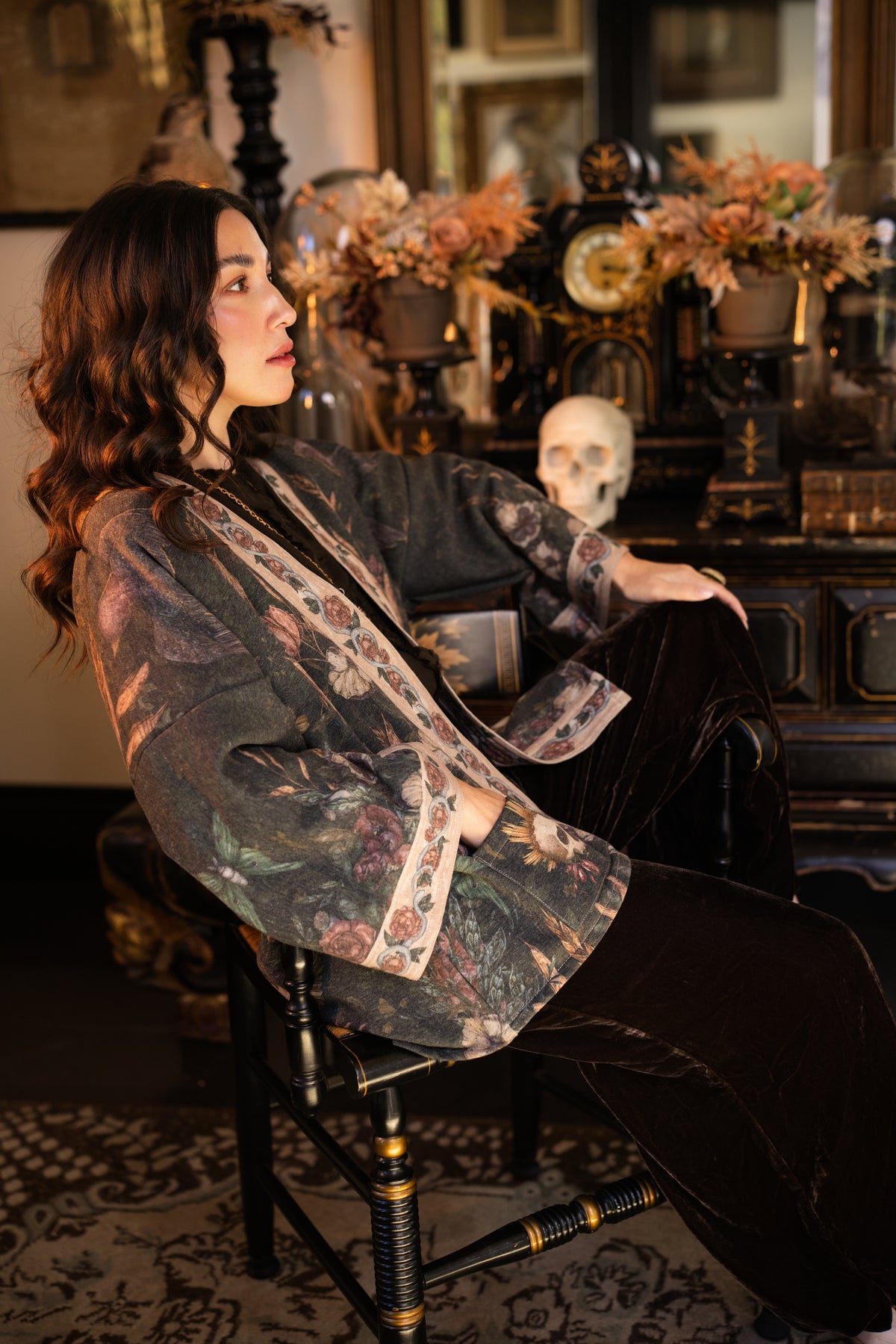 Model wearing a cozy fleece lined cottage cardigan ft. artwork created by Jessica Roux including two starlings beneath a full moon with flowers, butterflies, moths and botanical artwork - Market of Stars