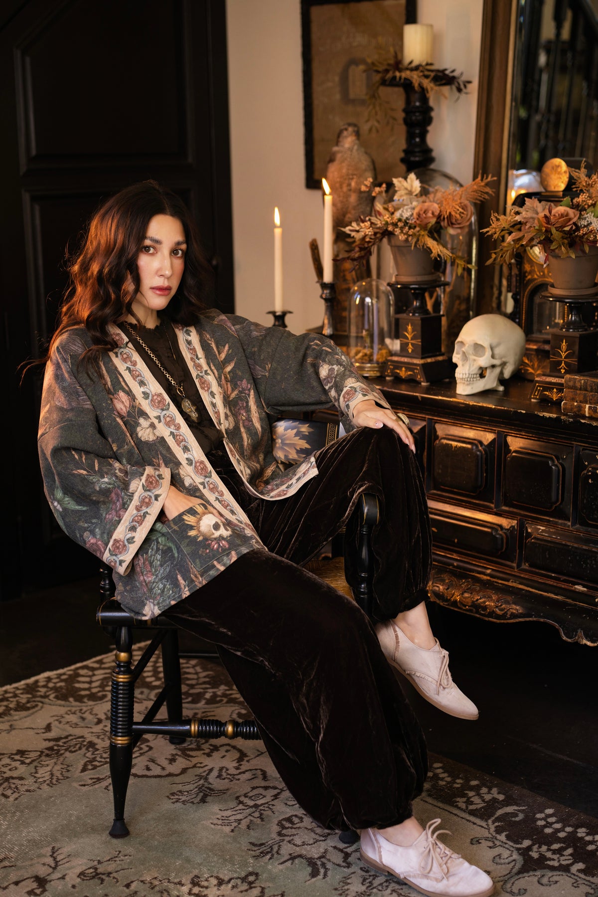 Model wearing a cozy fleece lined cottage cardigan ft. artwork created by Jessica Roux including two starlings beneath a full moon with flowers, butterflies, moths and botanical artwork - Market of Stars