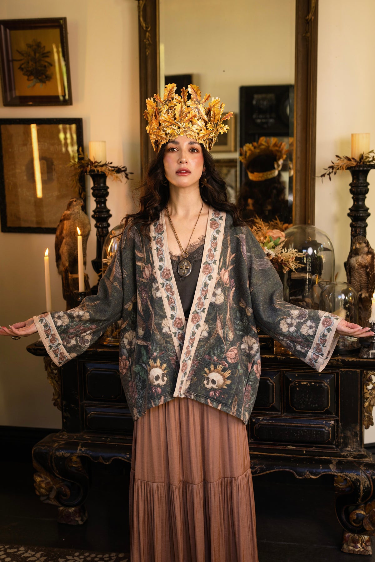 Model wearing a cozy fleece lined cottage cardigan ft. artwork created by Jessica Roux including two starlings beneath a full moon with flowers, butterflies, moths and botanical artwork - Market of Stars