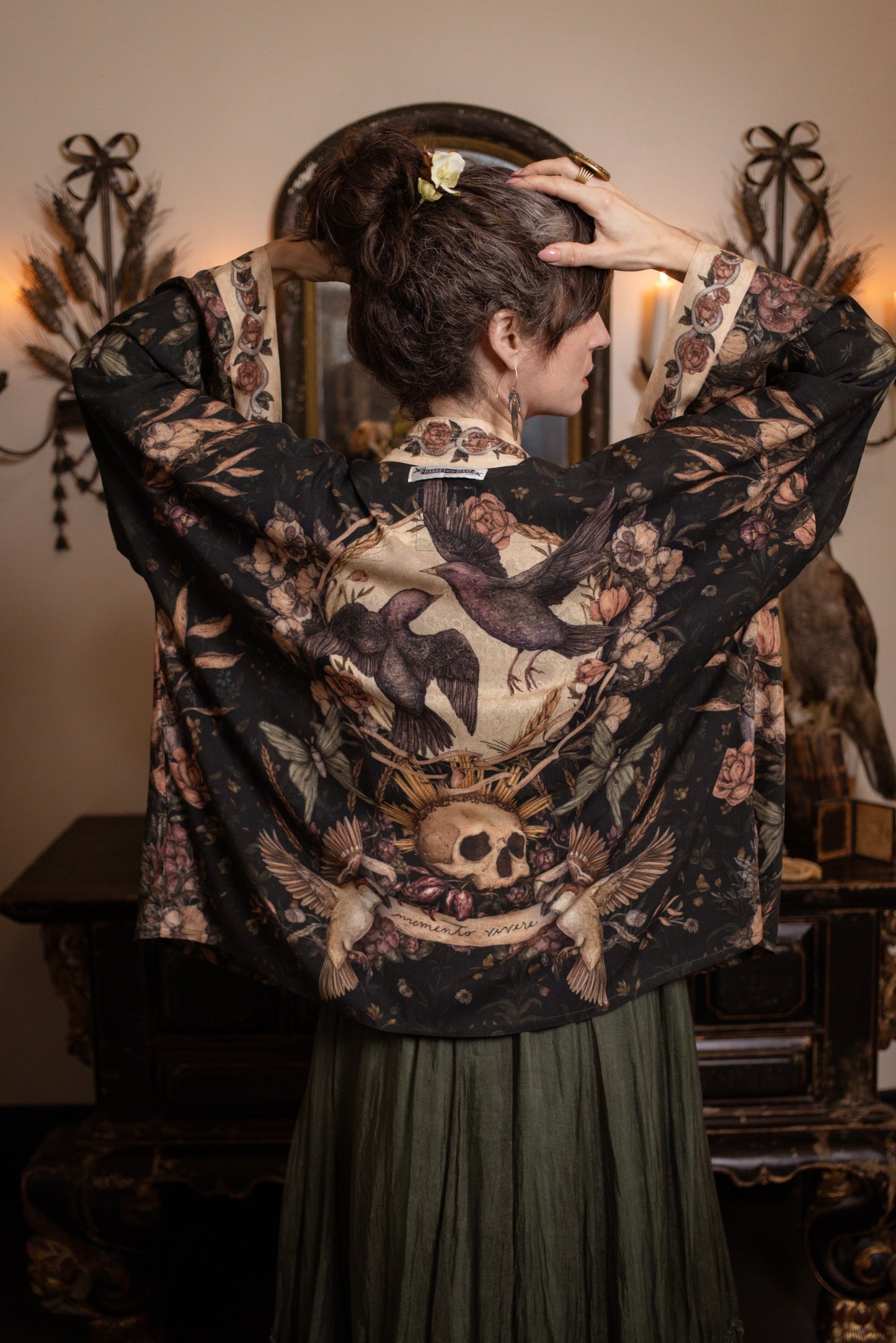 Model wearing a cropped-length duster ft. artwork created by Jessica Roux including two starlings beneath a full moon with flowers, butterflies, moths and botanical artwork - Market of Stars