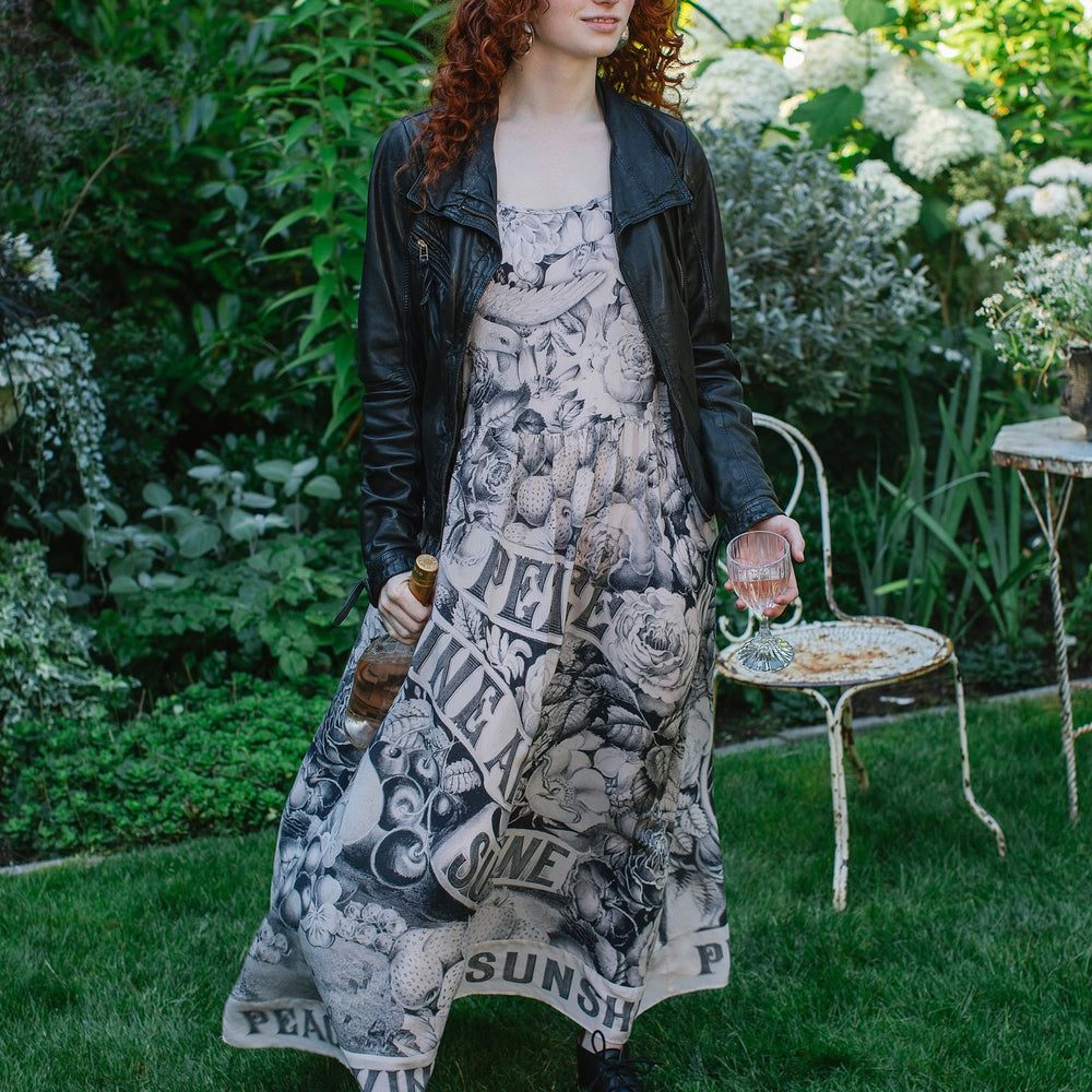 Model wearing Peace, Wine & Sunshine Bohéme Slip Dress featuring botanical collages and playful peace, wine and sunshine lettering on the hem – Market of Stars.