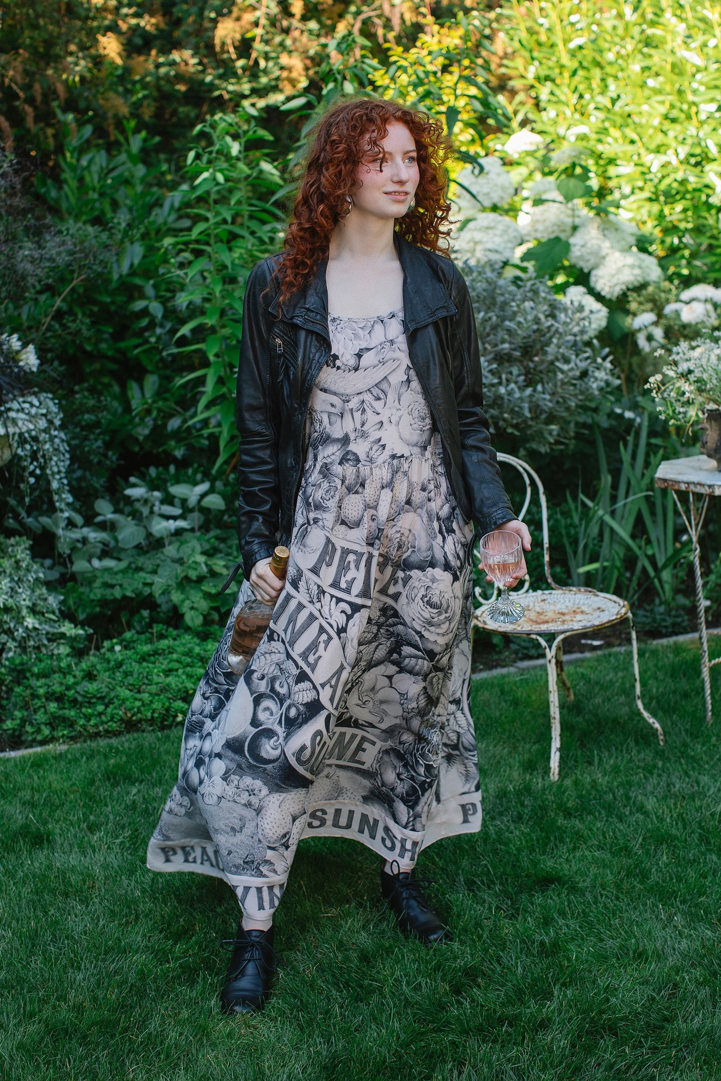 Model wearing Peace, Wine & Sunshine Bohéme Slip Dress featuring botanical collages and playful peace, wine and sunshine lettering on the hem – Market of Stars.