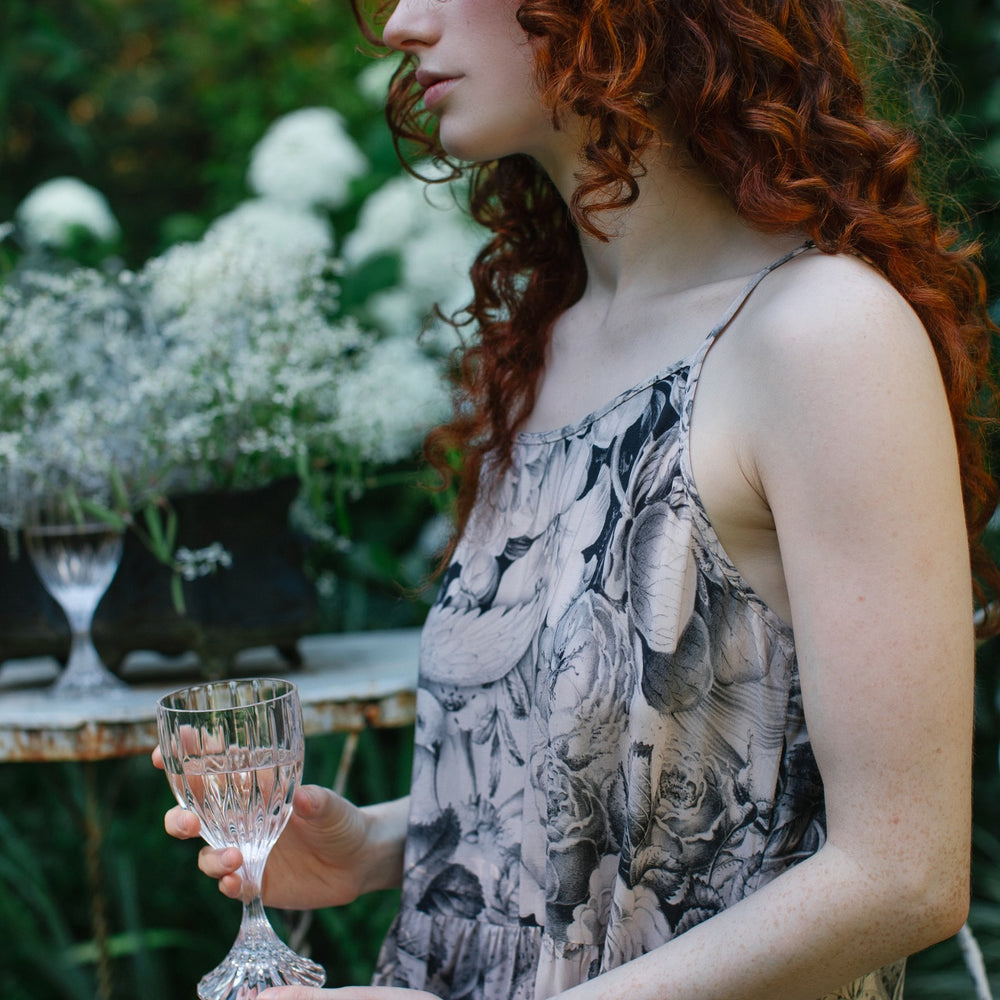 
                  
                    Model wearing Peace, Wine & Sunshine Bohéme Slip Dress featuring botanical collages and playful peace, wine and sunshine lettering on the hem – Market of Stars.
                  
                