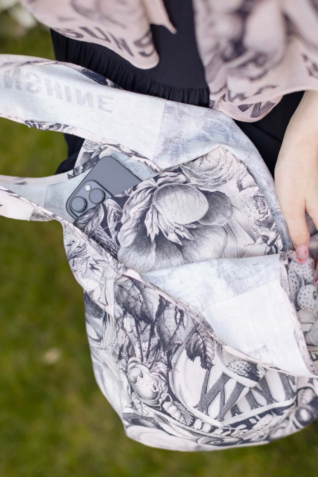 Model wearing a linen tote bag for everyday adventures with a whimsical print celebrating life's simple pleasures - Market of Stars