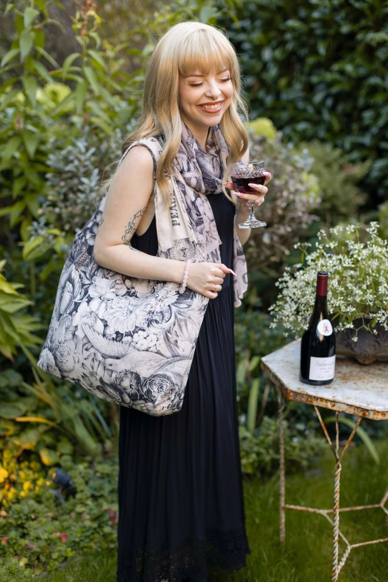 Model wearing a linen tote bag for everyday adventures with a whimsical print celebrating life's simple pleasures - Market of Stars