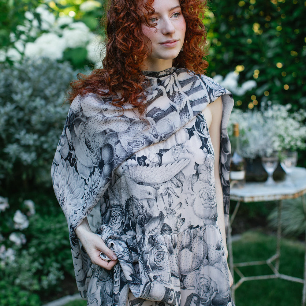Model wearing Peace, Wine & Sunshine Bohéme Slip Dress featuring botanical collages and playful peace, wine and sunshine lettering on the hem – Market of Stars.