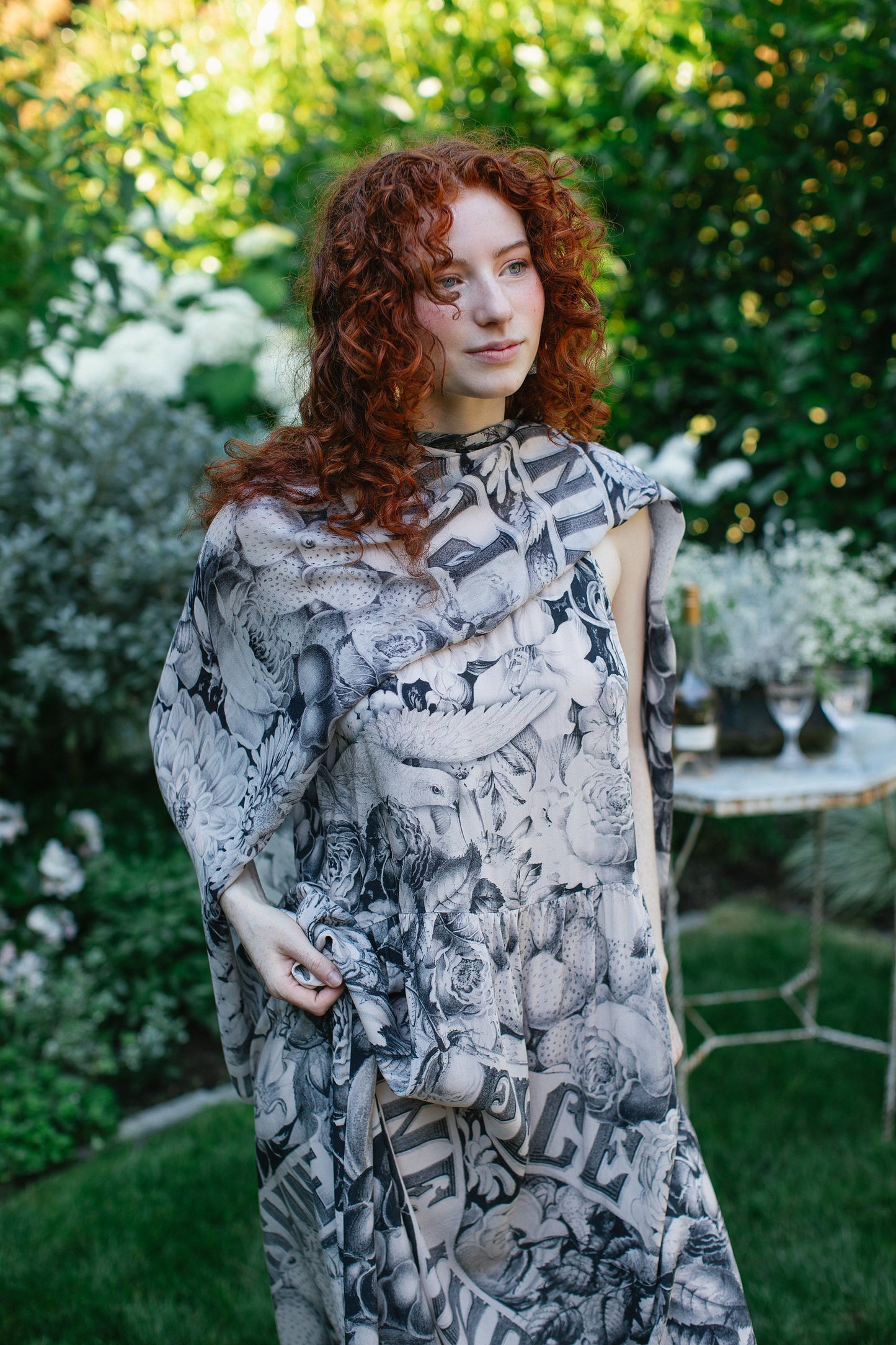 Model wearing Peace, Wine & Sunshine Bohéme Slip Dress featuring botanical collages and playful peace, wine and sunshine lettering on the hem – Market of Stars.
