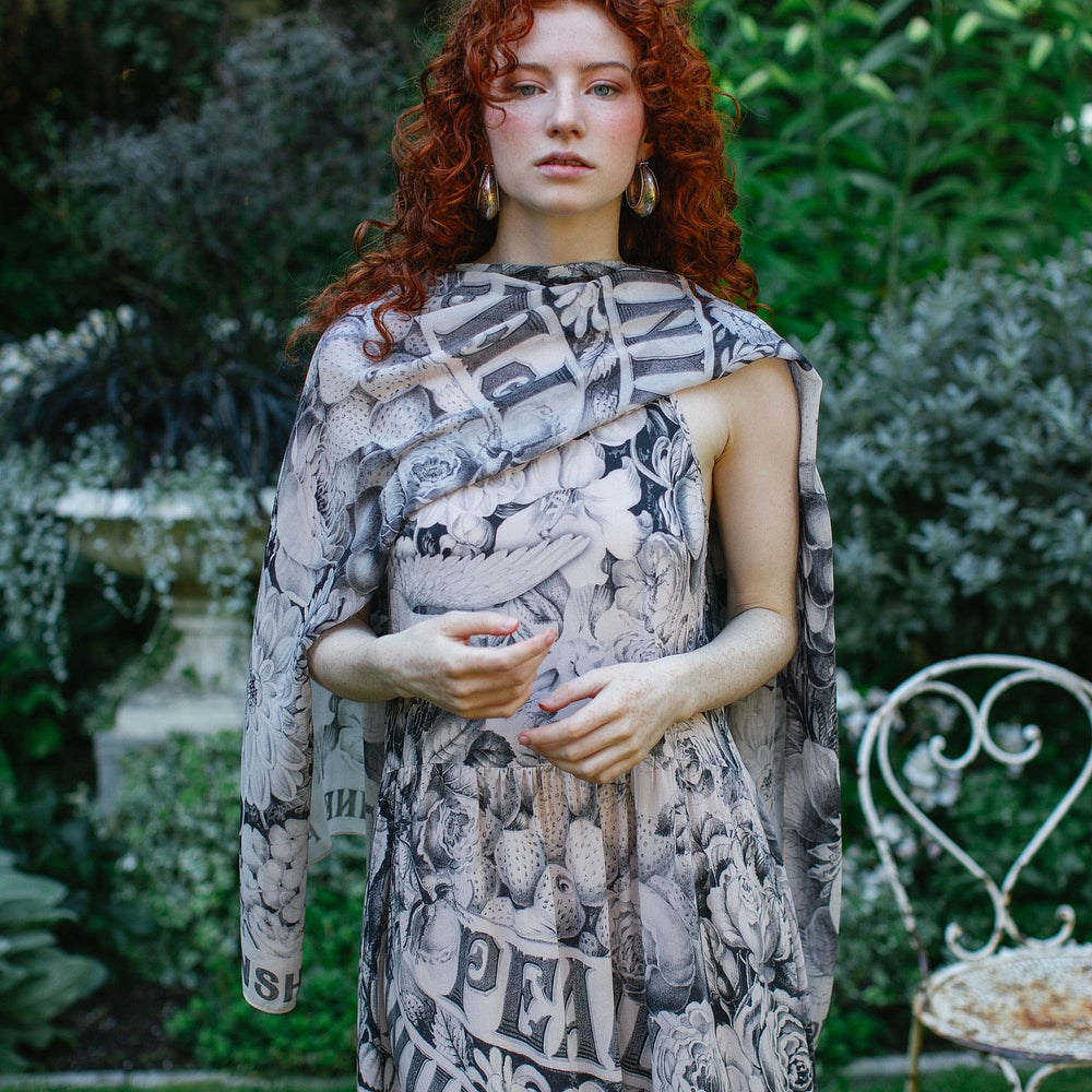 
                  
                    Model wearing Peace, Wine & Sunshine Bohéme Slip Dress featuring botanical collages and playful peace, wine and sunshine lettering on the hem – Market of Stars.
                  
                