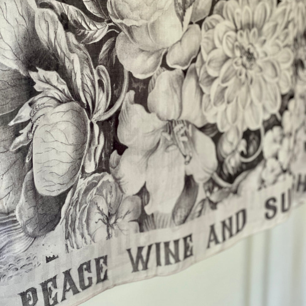 
                  
                    Model wearing Peace, Wine & Sunshine Bohéme Slip Dress featuring botanical collages and playful peace, wine and sunshine lettering on the hem – Market of Stars.
                  
                