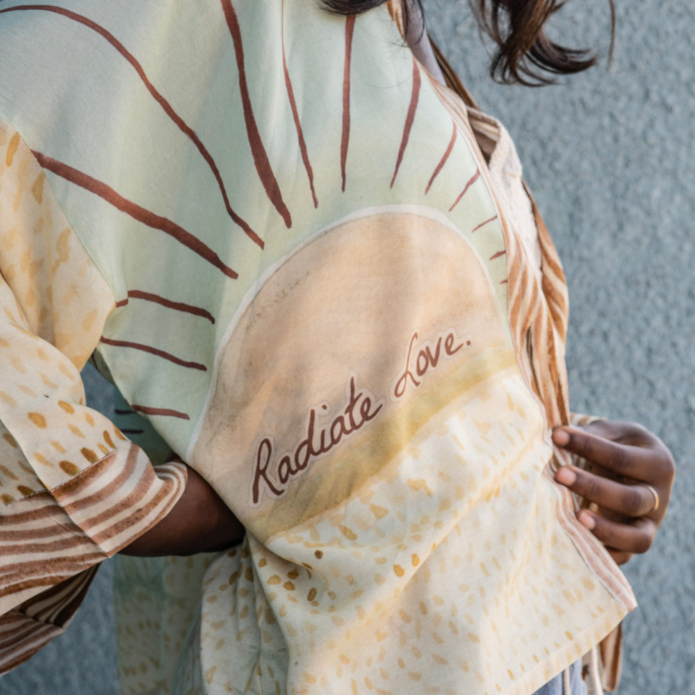 
                  
                    Model wearing Peace, Wine & Sunshine Bohéme Slip Dress featuring botanical collages and playful peace, wine and sunshine lettering on the hem – Market of Stars.
                  
                