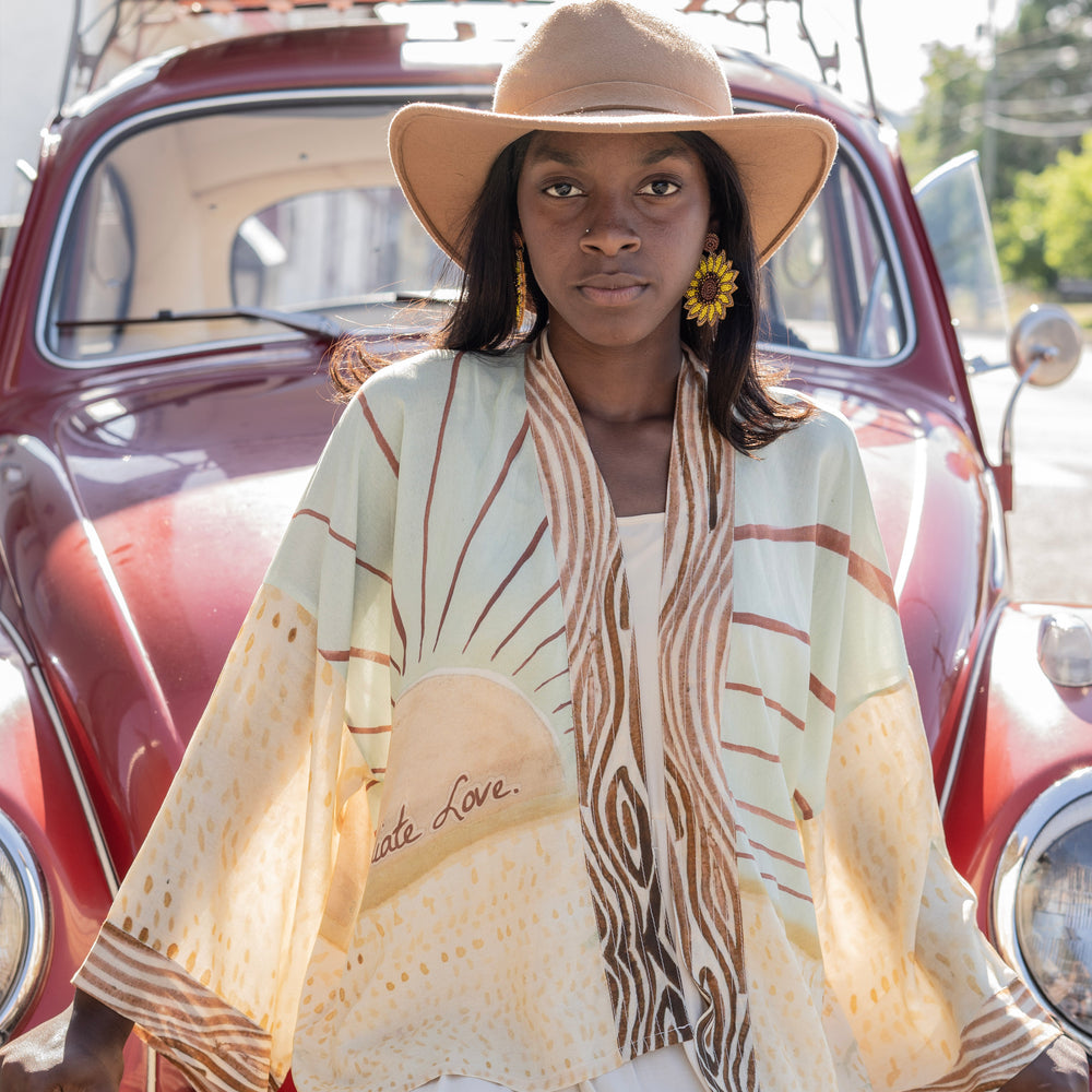 
                  
                    Model wearing Peace, Wine & Sunshine Bohéme Slip Dress featuring botanical collages and playful peace, wine and sunshine lettering on the hem – Market of Stars.
                  
                