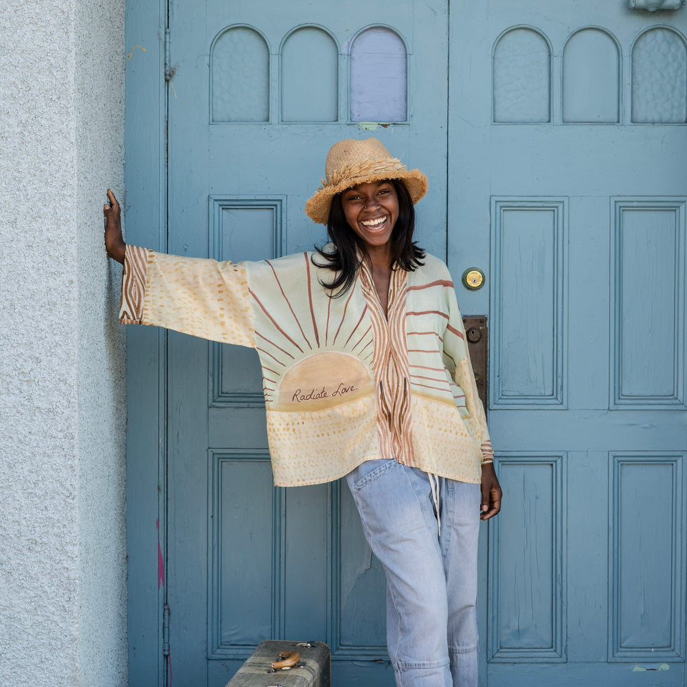 
                  
                    Model wearing Peace, Wine & Sunshine Bohéme Slip Dress featuring botanical collages and playful peace, wine and sunshine lettering on the hem – Market of Stars.
                  
                