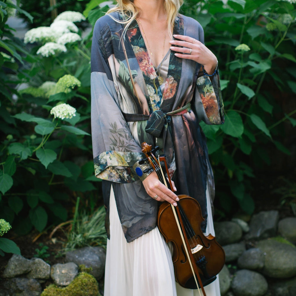 
                  
                    Model wearing Peace, Wine & Sunshine Bohéme Slip Dress featuring botanical collages and playful peace, wine and sunshine lettering on the hem – Market of Stars.
                  
                