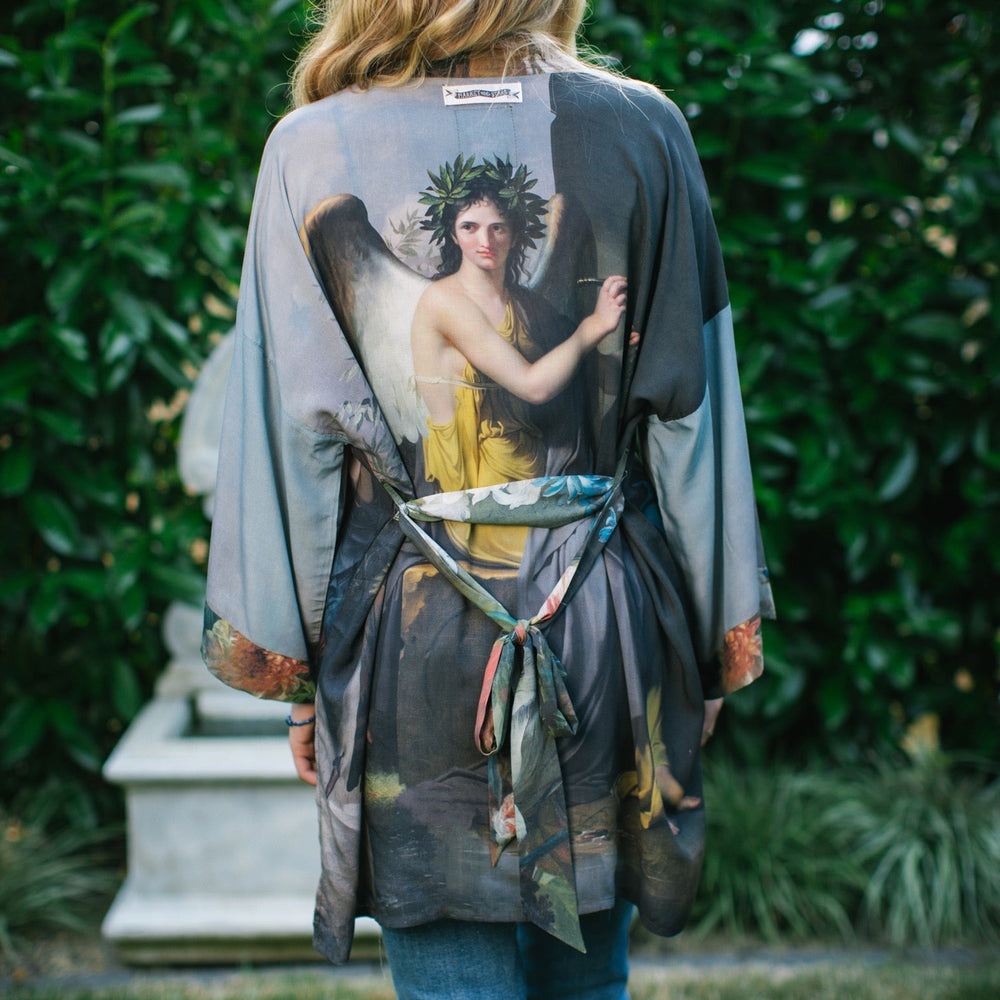 
                  
                    Model wearing Peace, Wine & Sunshine Bohéme Slip Dress featuring botanical collages and playful peace, wine and sunshine lettering on the hem – Market of Stars.
                  
                
