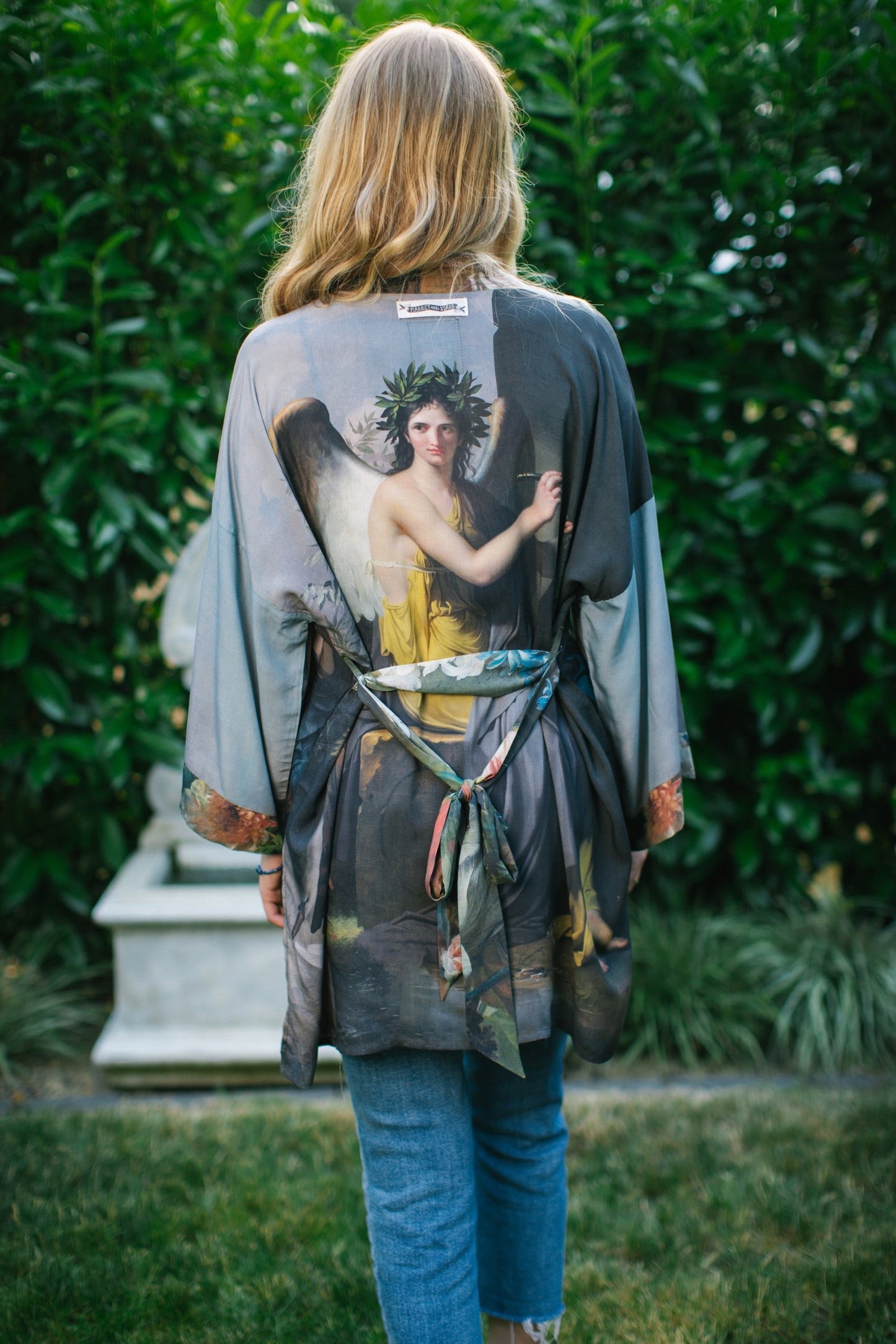 Model wearing Peace, Wine & Sunshine Bohéme Slip Dress featuring botanical collages and playful peace, wine and sunshine lettering on the hem – Market of Stars.