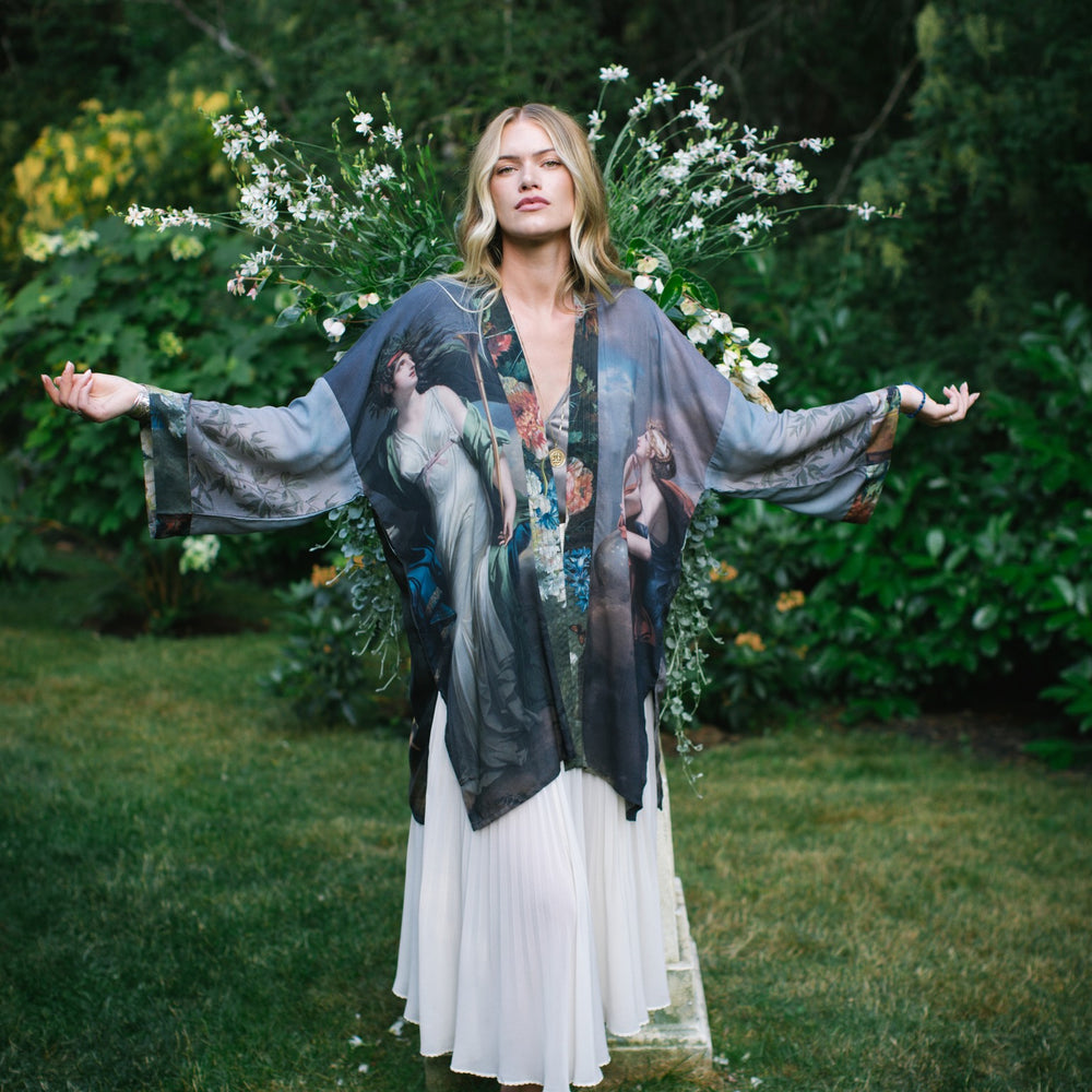 
                  
                    Model wearing Peace, Wine & Sunshine Bohéme Slip Dress featuring botanical collages and playful peace, wine and sunshine lettering on the hem – Market of Stars.
                  
                