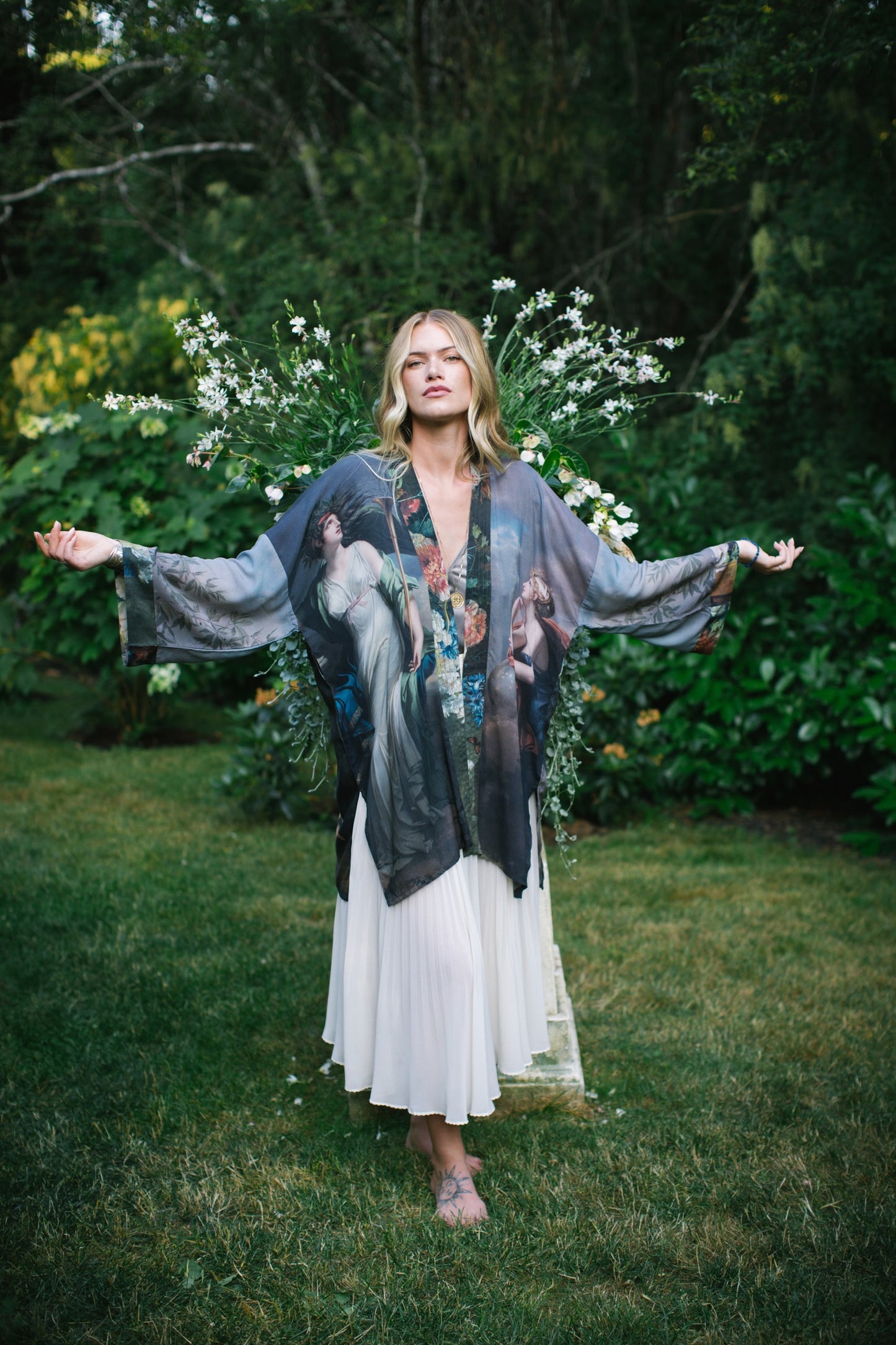 Model wearing Peace, Wine & Sunshine Bohéme Slip Dress featuring botanical collages and playful peace, wine and sunshine lettering on the hem – Market of Stars.