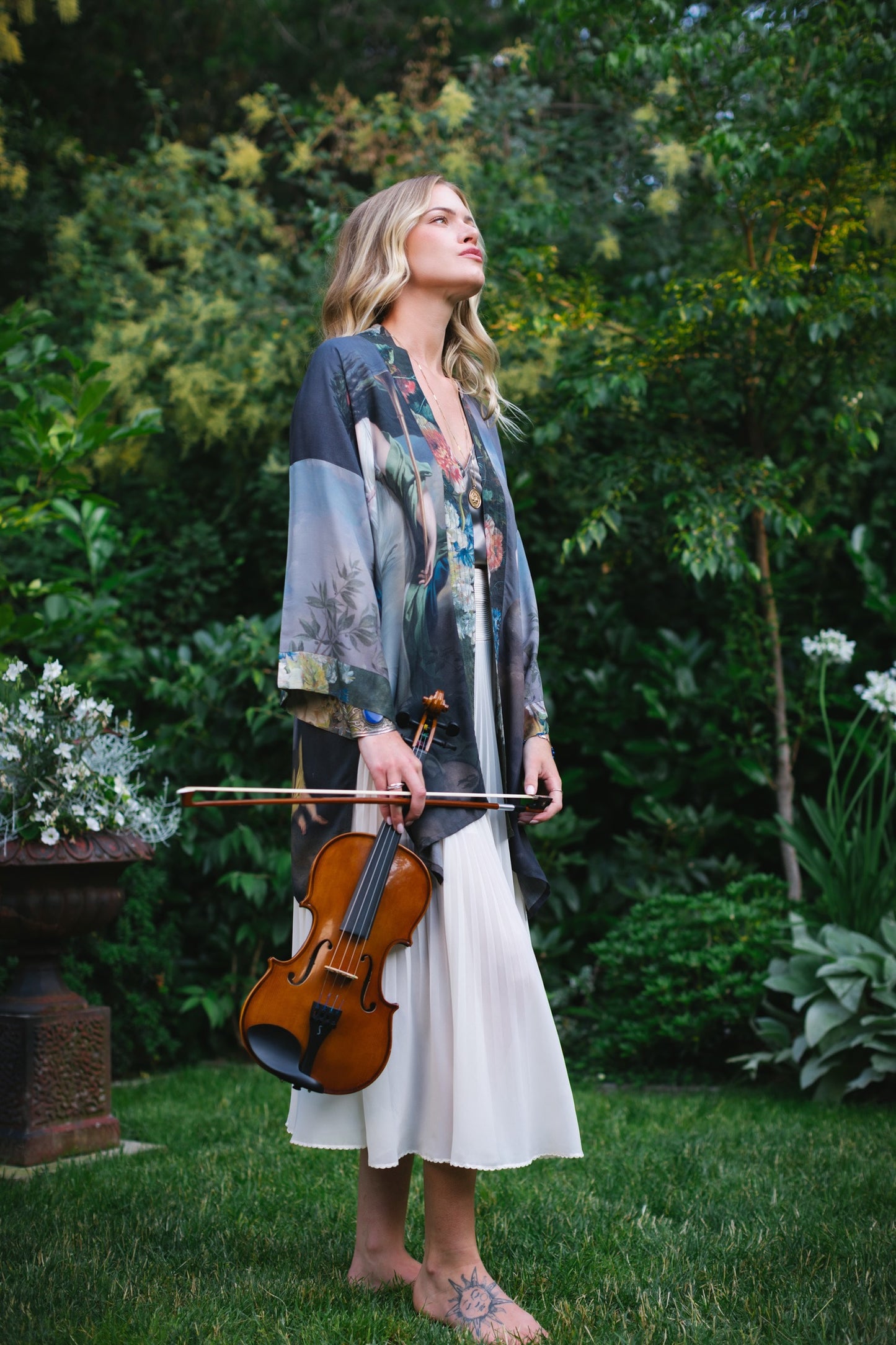 Model wearing Peace, Wine & Sunshine Bohéme Slip Dress featuring botanical collages and playful peace, wine and sunshine lettering on the hem – Market of Stars.