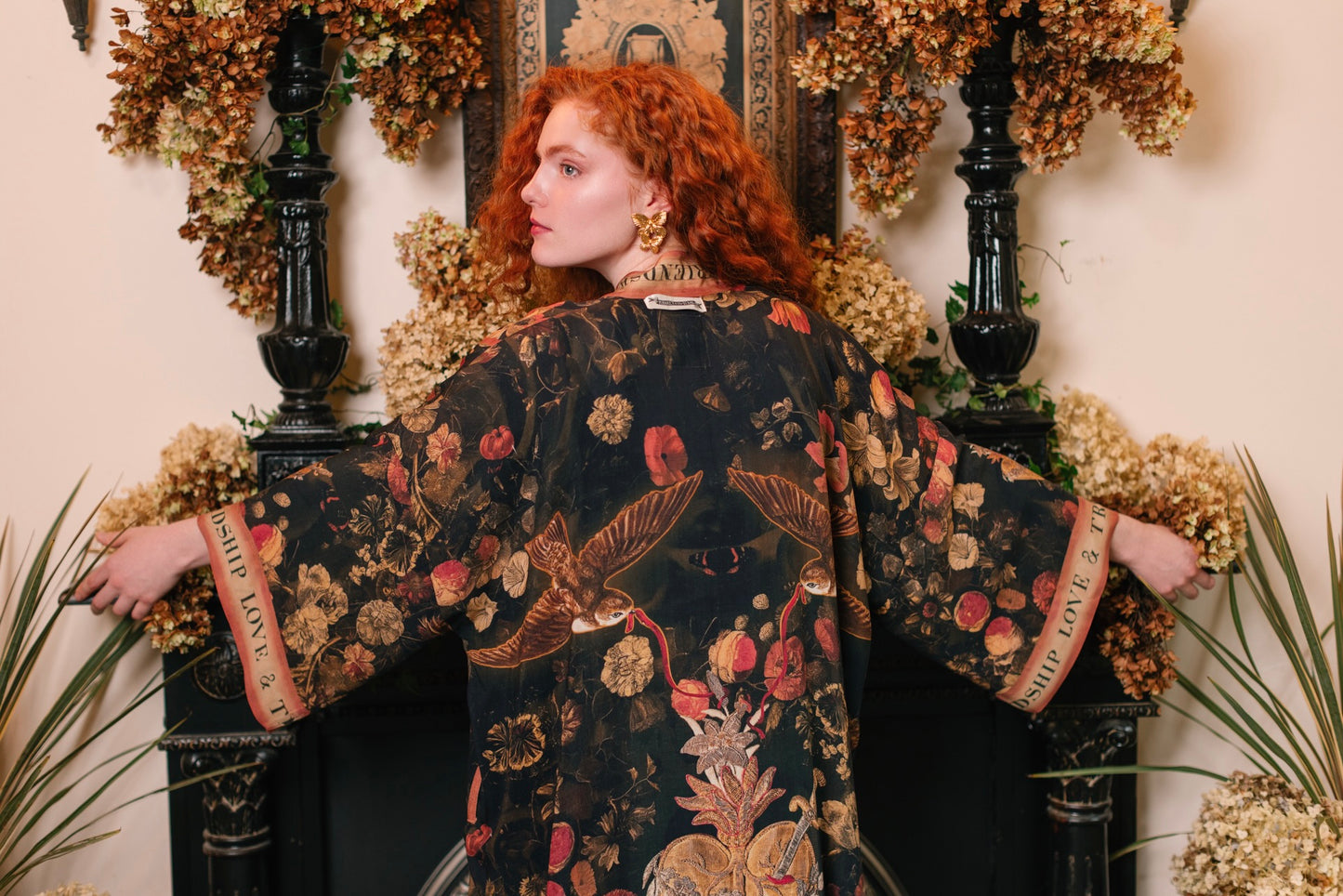Model wearing a full-length bamboo-viscose duster featuring a collage of antique artwork with romance, loyalty, and old-world beauty - Market of Stars