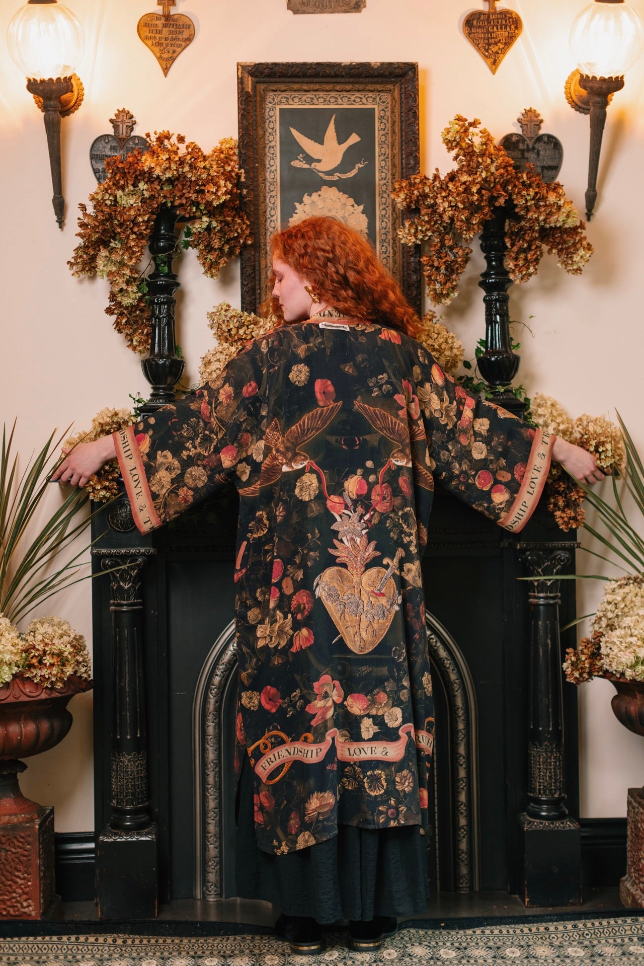 Model wearing a full-length bamboo-viscose duster featuring a collage of antique artwork with romance, loyalty, and old-world beauty - Market of Stars