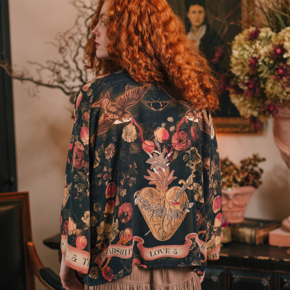 Model wearing a cropped-length bamboo-viscose duster featuring a collage of antique artwork with romance, loyalty, and old-world beauty - Market of Stars