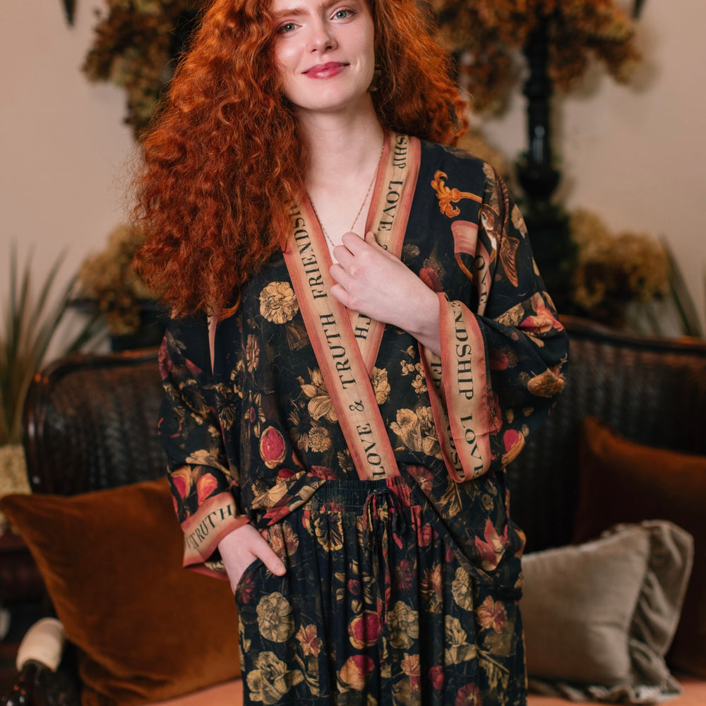 
                  
                    Model wearing a cropped-length bamboo-viscose duster featuring a collage of antique artwork with romance, loyalty, and old-world beauty - Market of Stars
                  
                